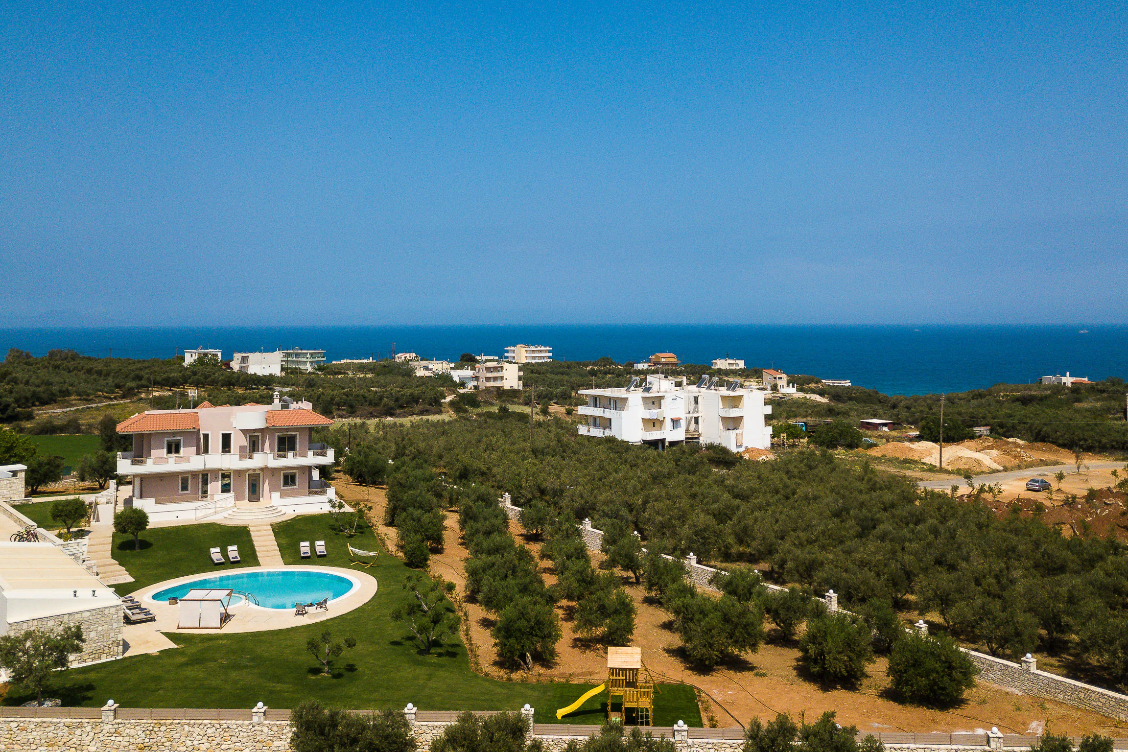 Closer aerial view of the villa, private pool and surrounding grounds