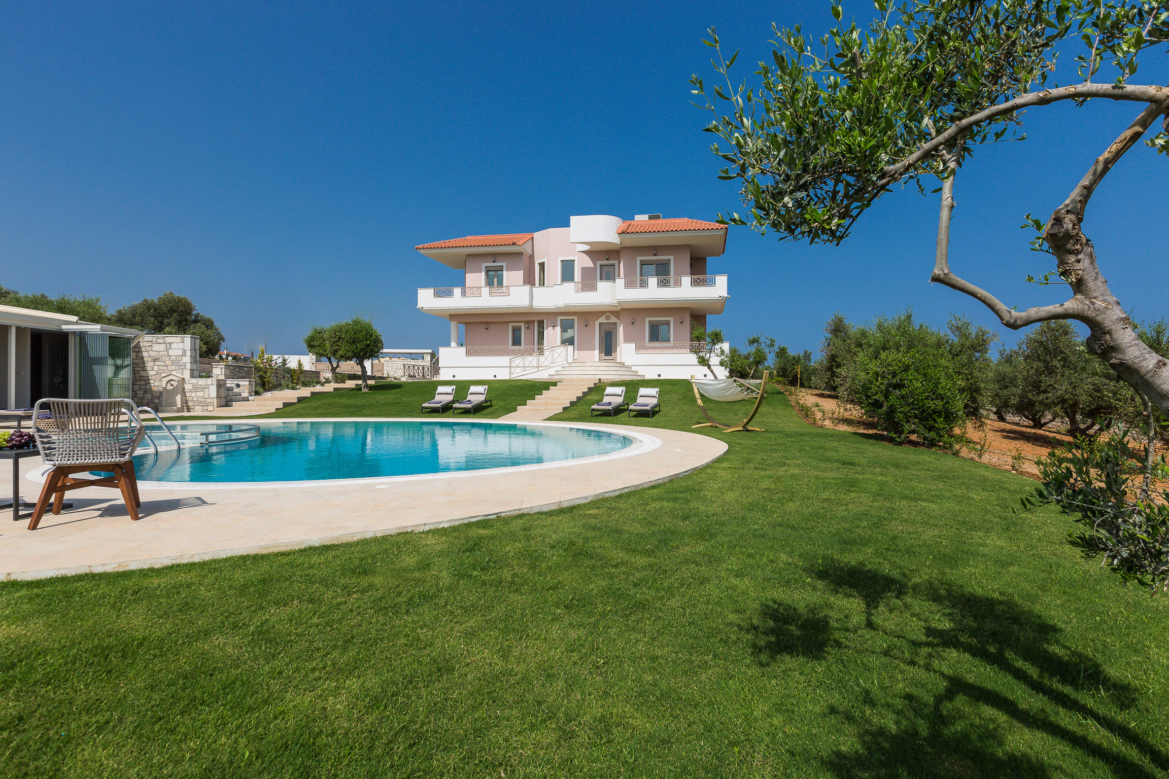 Wide lawn surrounding the private pool