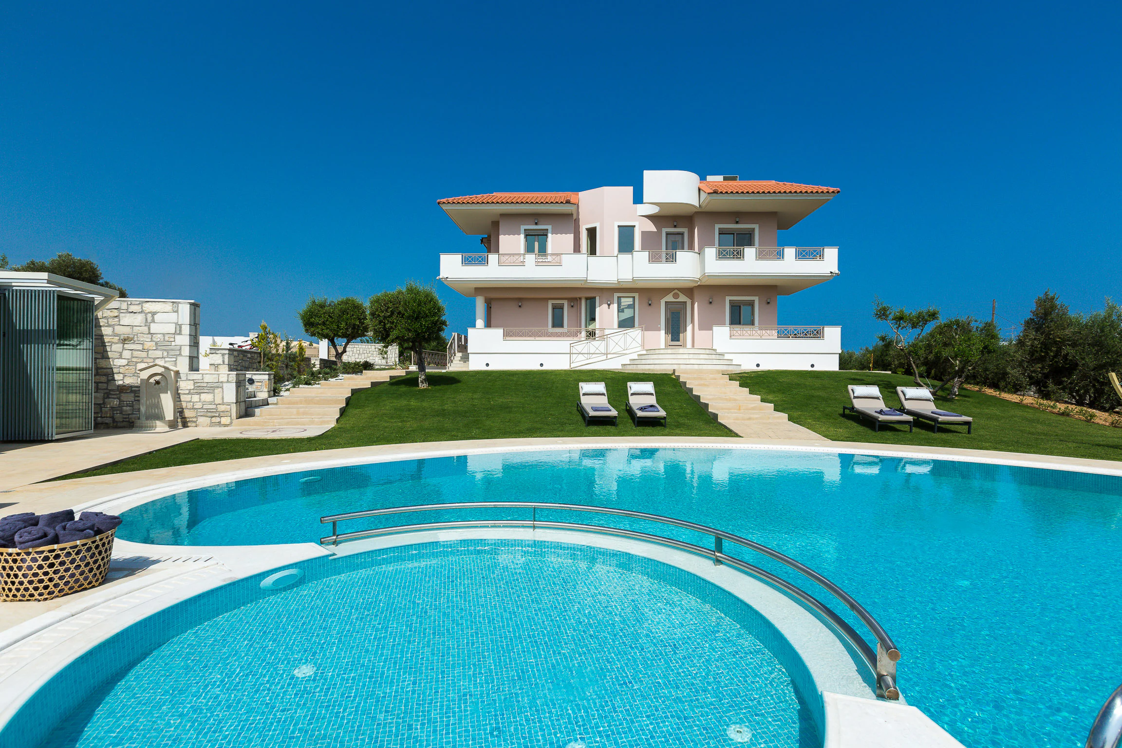 The 100 square metre pool with the separate round children's pool in front of it and the residence beyond