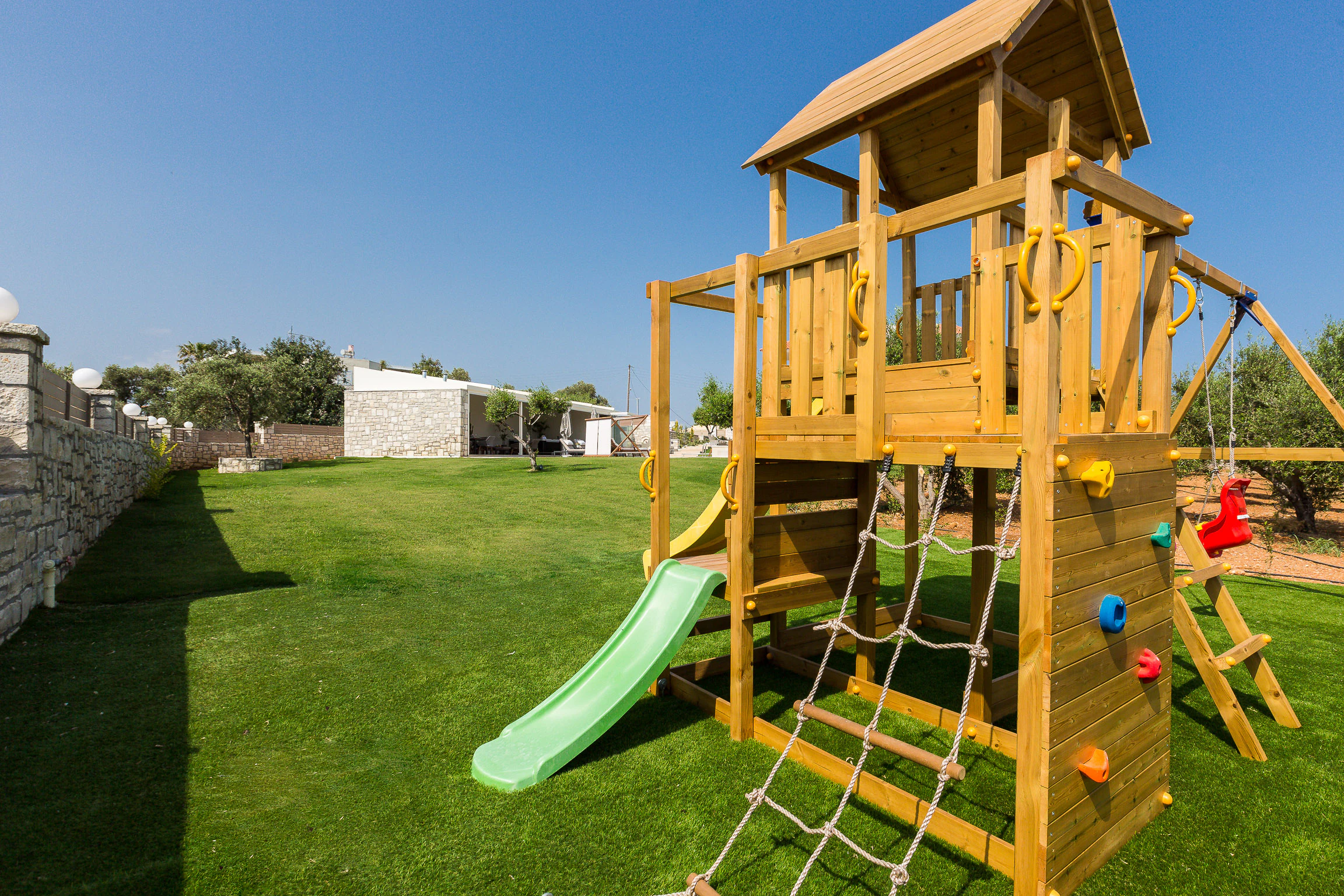 Children's wooden playground on the private lawn