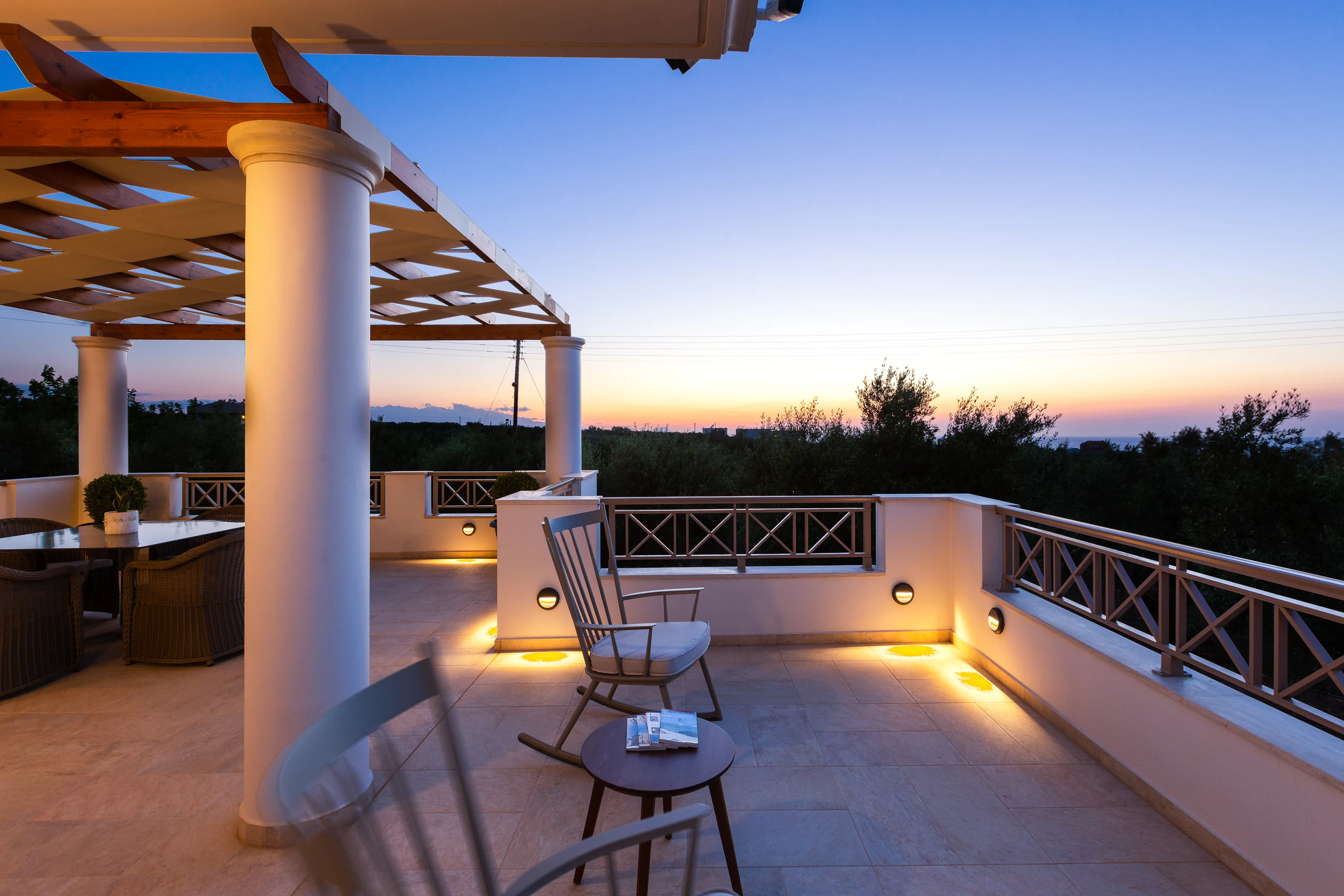 Upper terrace illuminated beneath a Cretan dusk sky