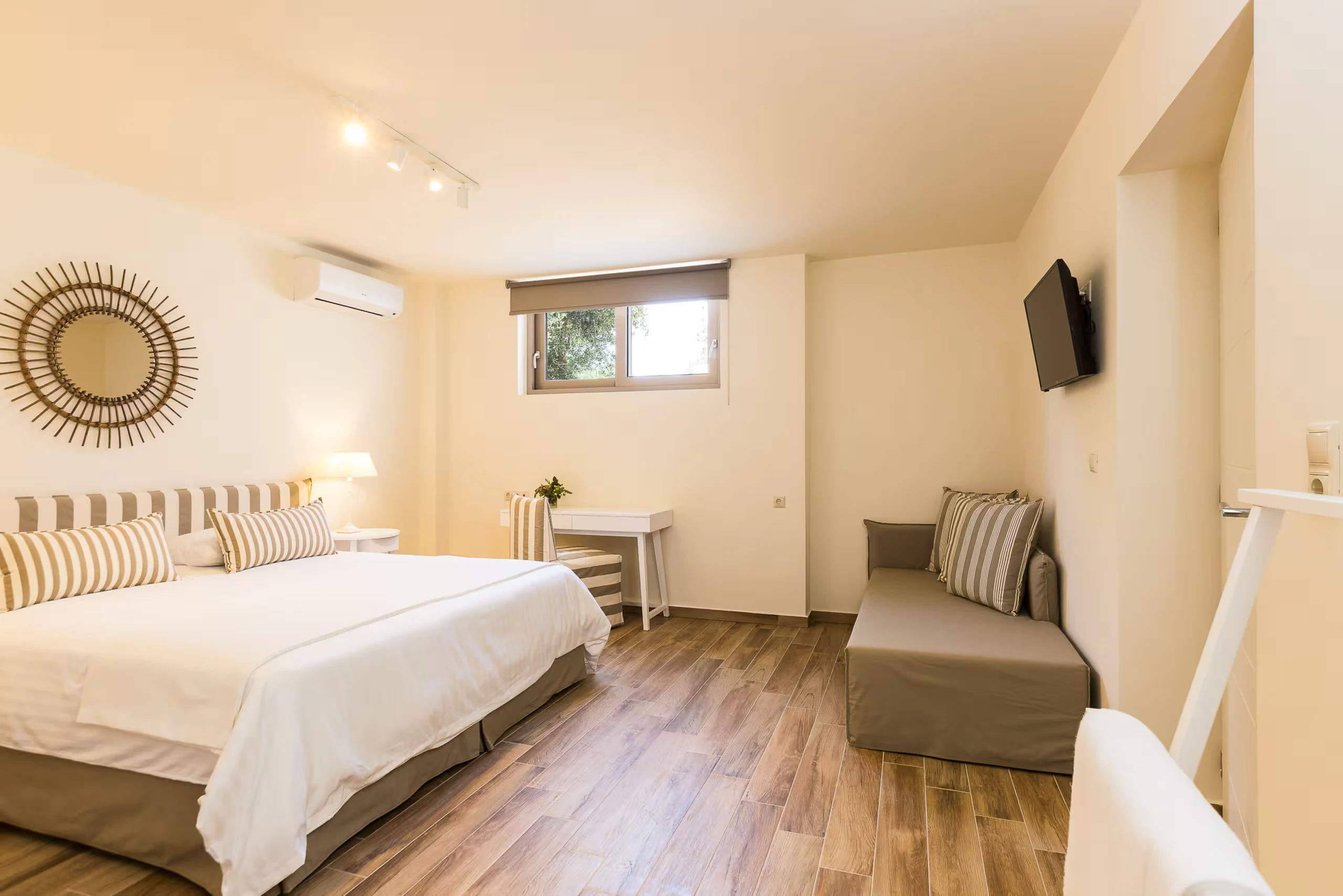 Lower-level double bedroom with a sofa bed, desk and wall-mounted television