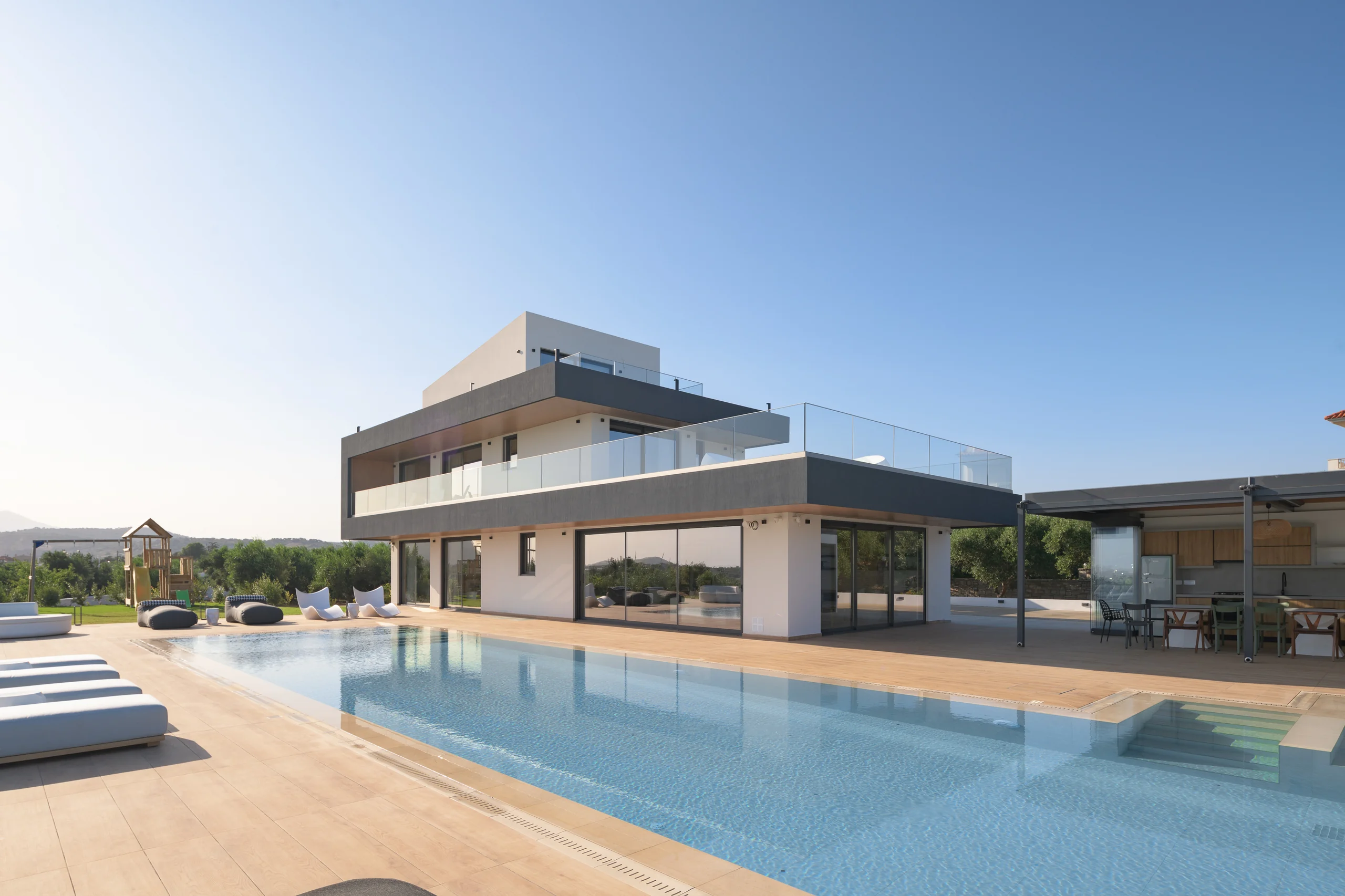 Wide pool-level view of the villa’s contemporary architecture at Aesthea Exclusive Villa