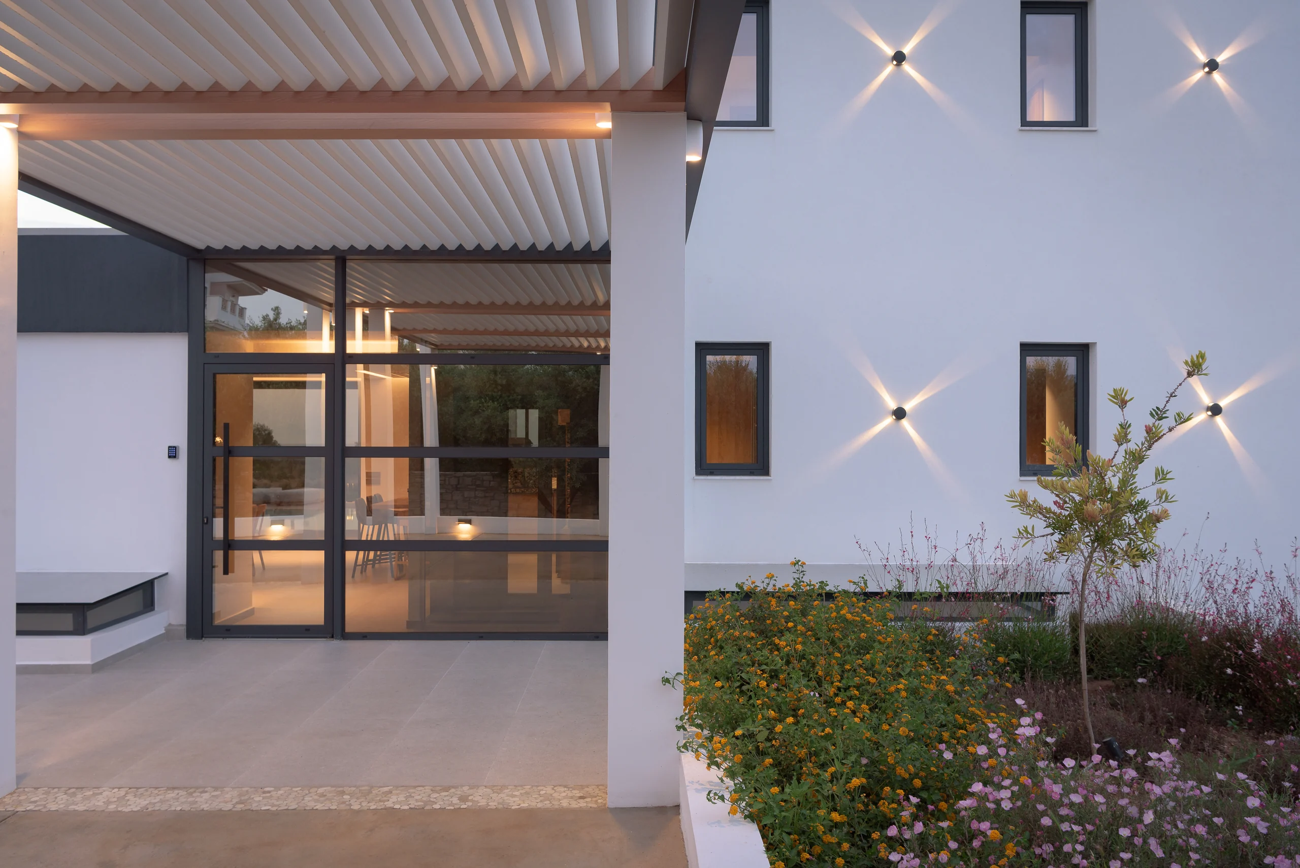 Main entrance illuminated at the end of the garden path at Aesthea Exclusive Villa