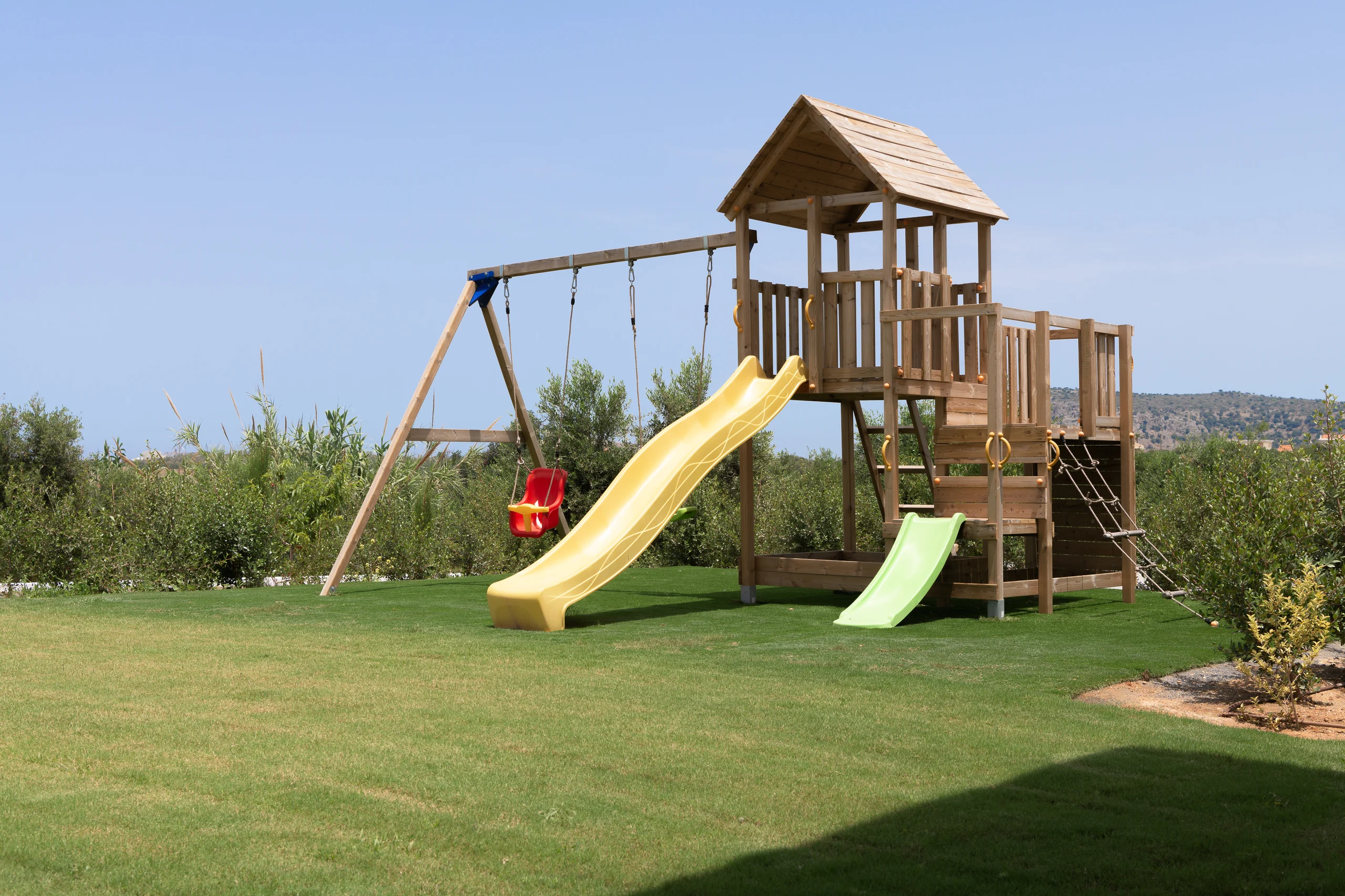 Children's timber playground on the villa's private lawn at Aesthea Exclusive Villa