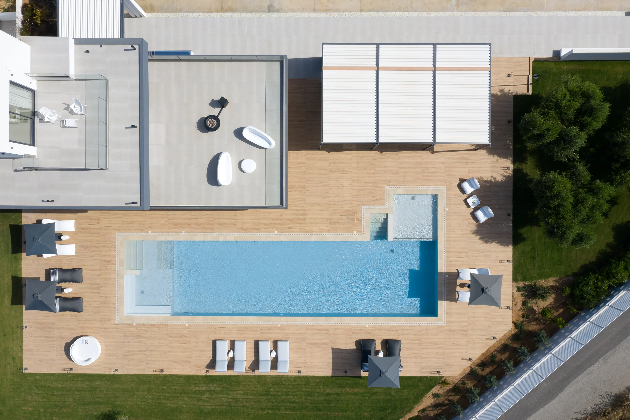 Panoramic view of both pools and the surrounding terraces at Aesthea Exclusive Villa