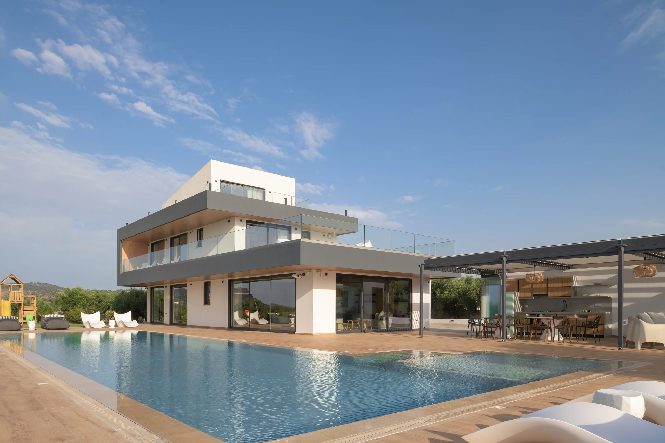 Pool-level architectural view with the pavilion beyond at Aesthea Exclusive Villa