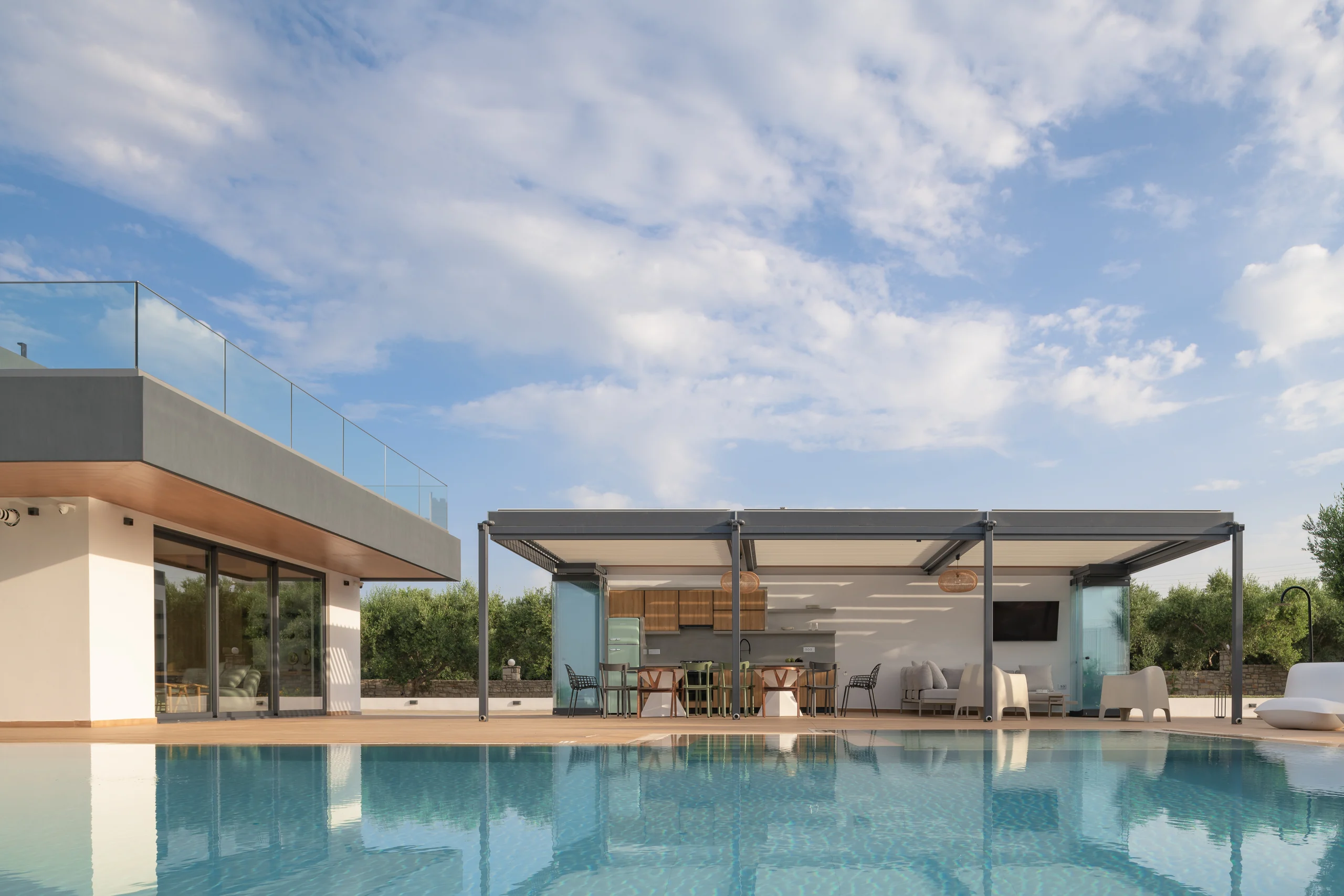 Wide pool view connecting the villa and dining pavilion at Aesthea Exclusive Villa