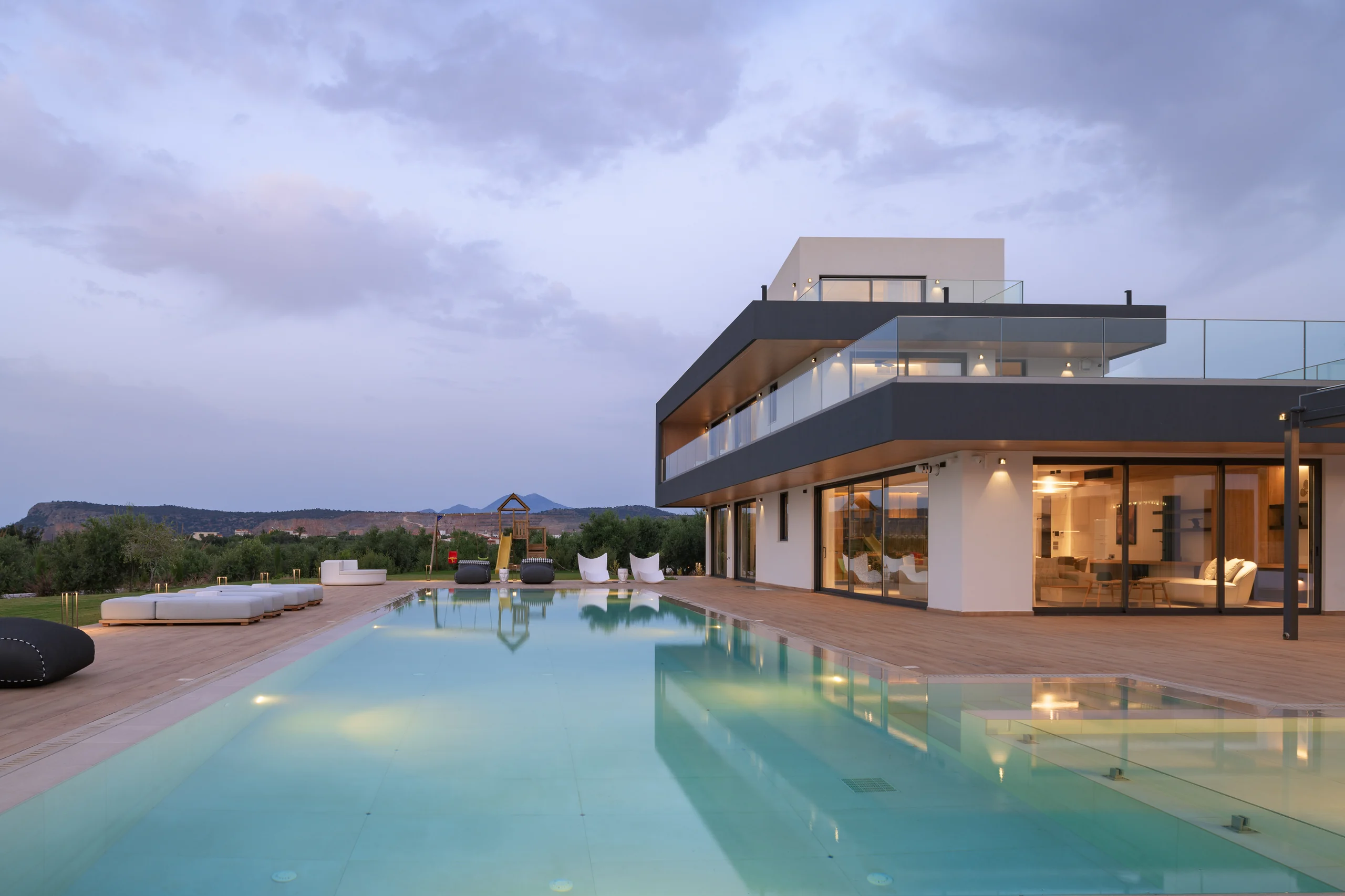 Pool and illuminated villa at blue hour at Aesthea Exclusive Villa
