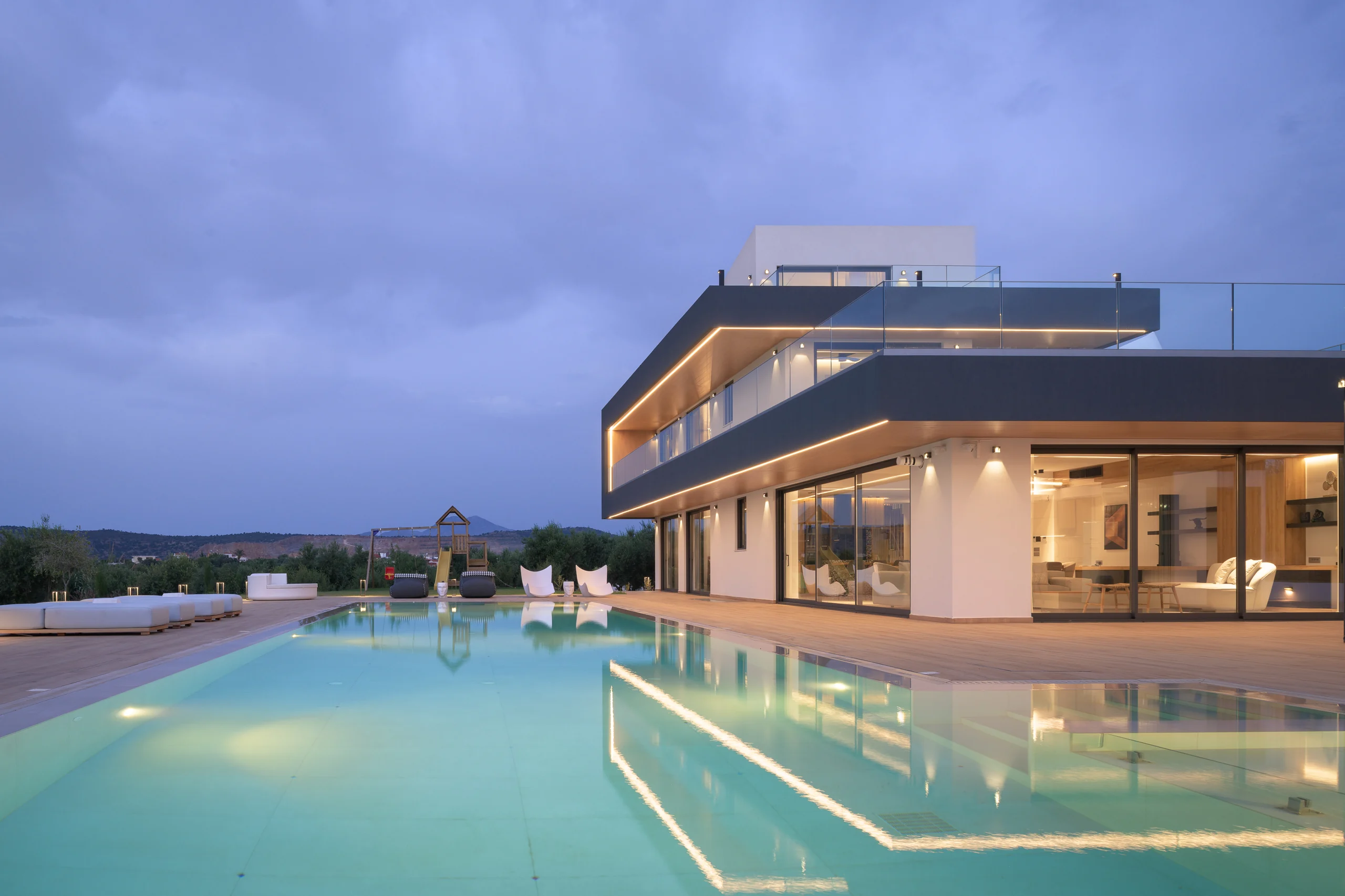 Wide blue-hour view across the water and villa at Aesthea Exclusive Villa