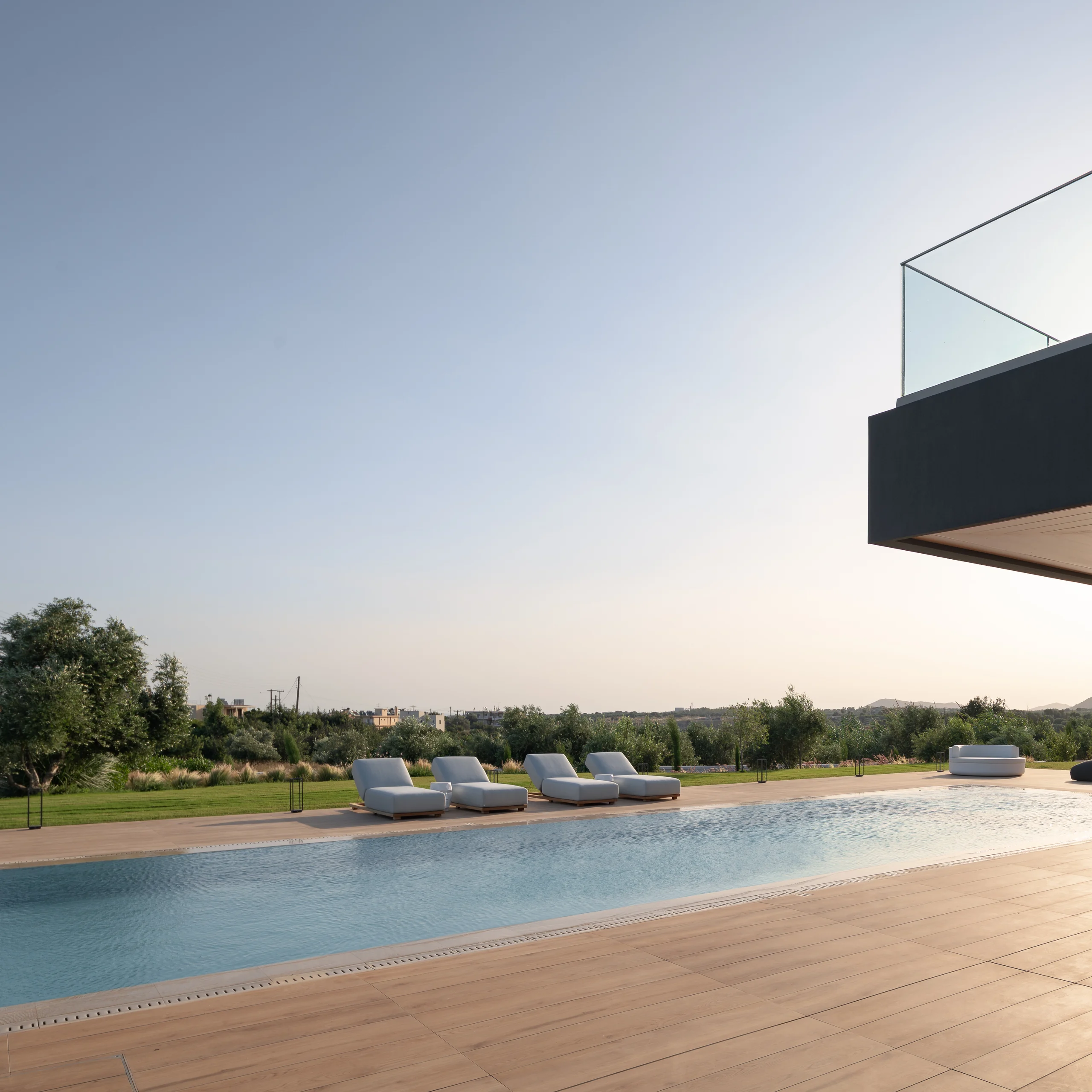 White sun loungers looking across the private landscape at Aesthea Exclusive Villa