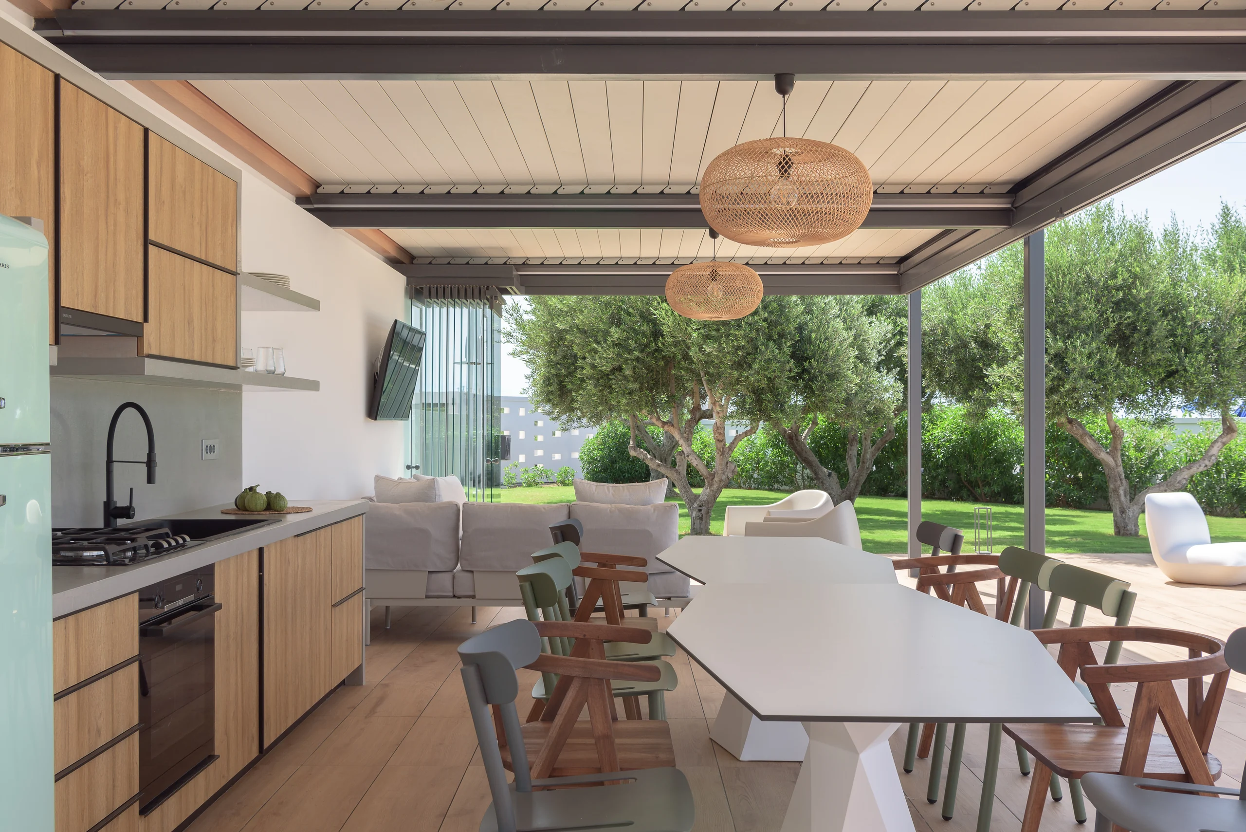 Covered alfresco dining table opening to the garden at Aesthea Exclusive Villa