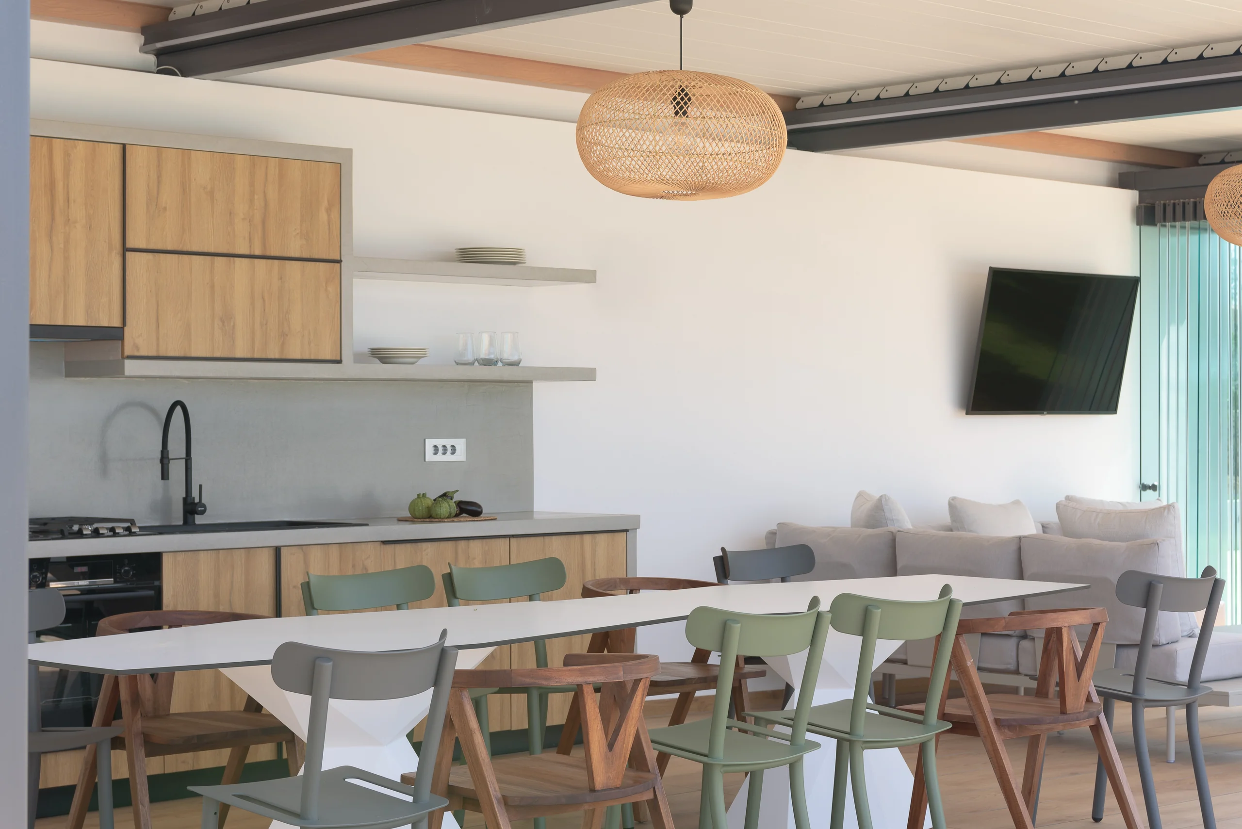 Outdoor kitchen and dining area beside the pool at Aesthea Exclusive Villa
