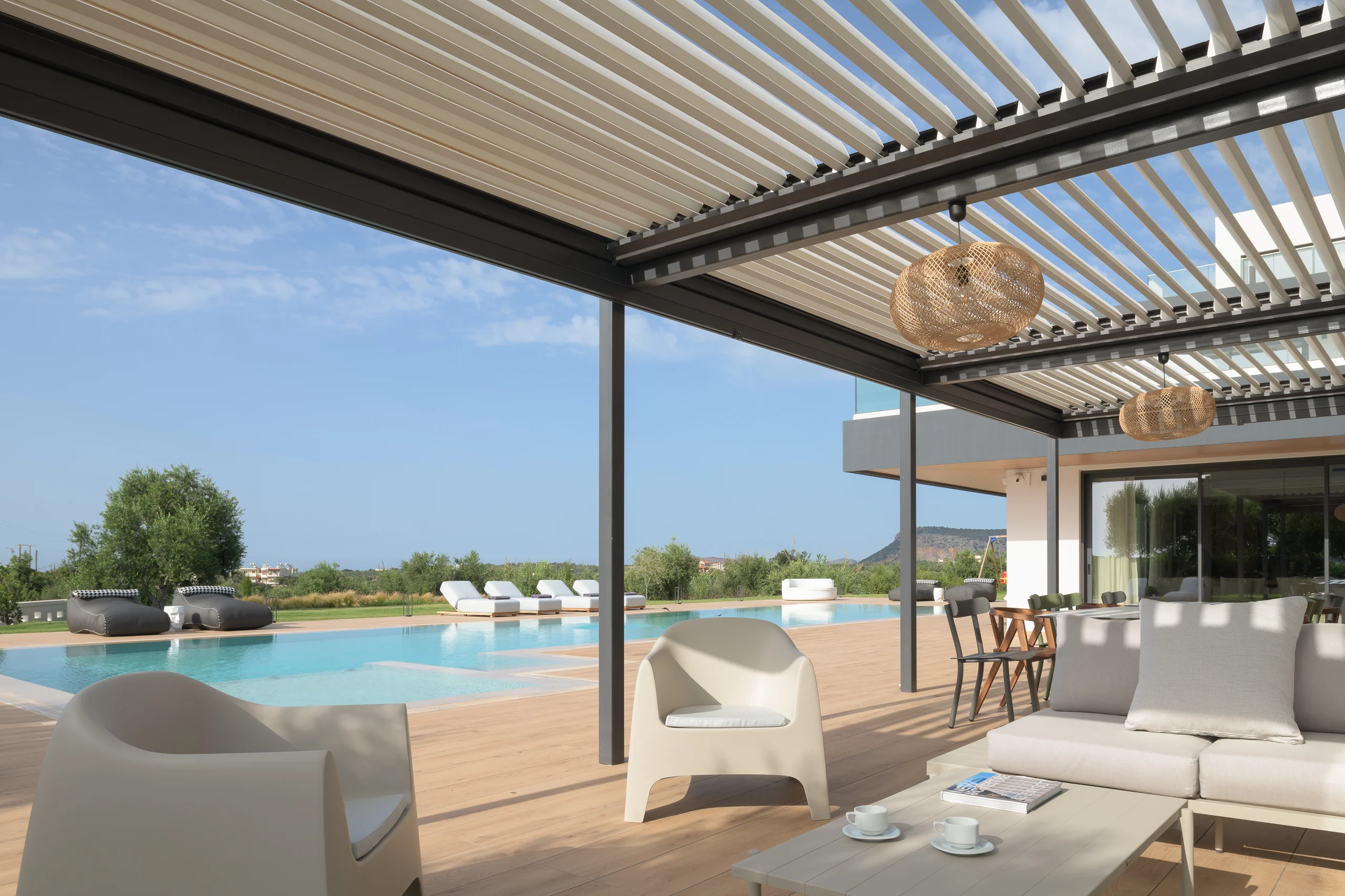 Dining and lounge settings arranged beside the water at Aesthea Exclusive Villa