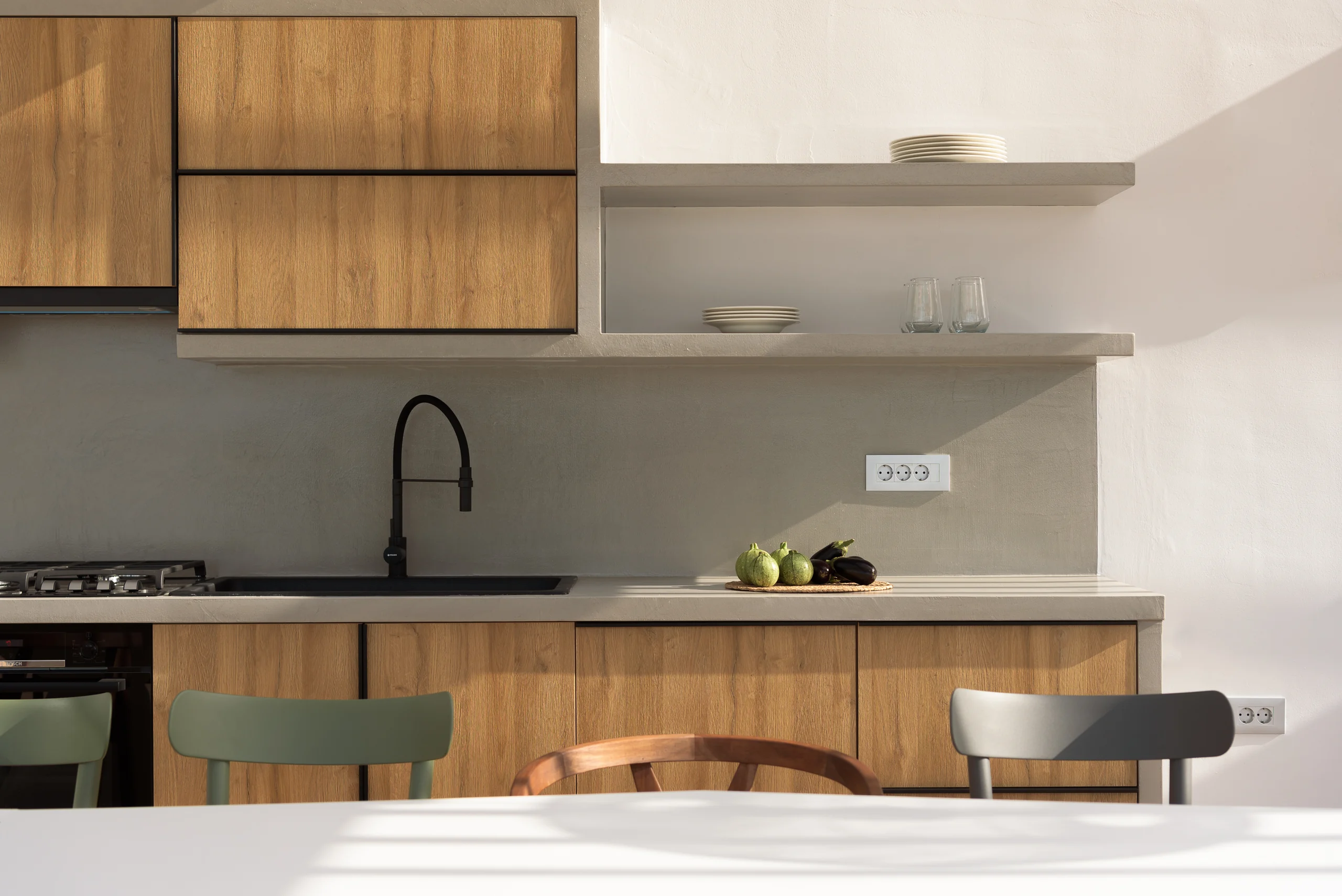 Outdoor kitchen tableware and timber cabinetry detail at Aesthea Exclusive Villa