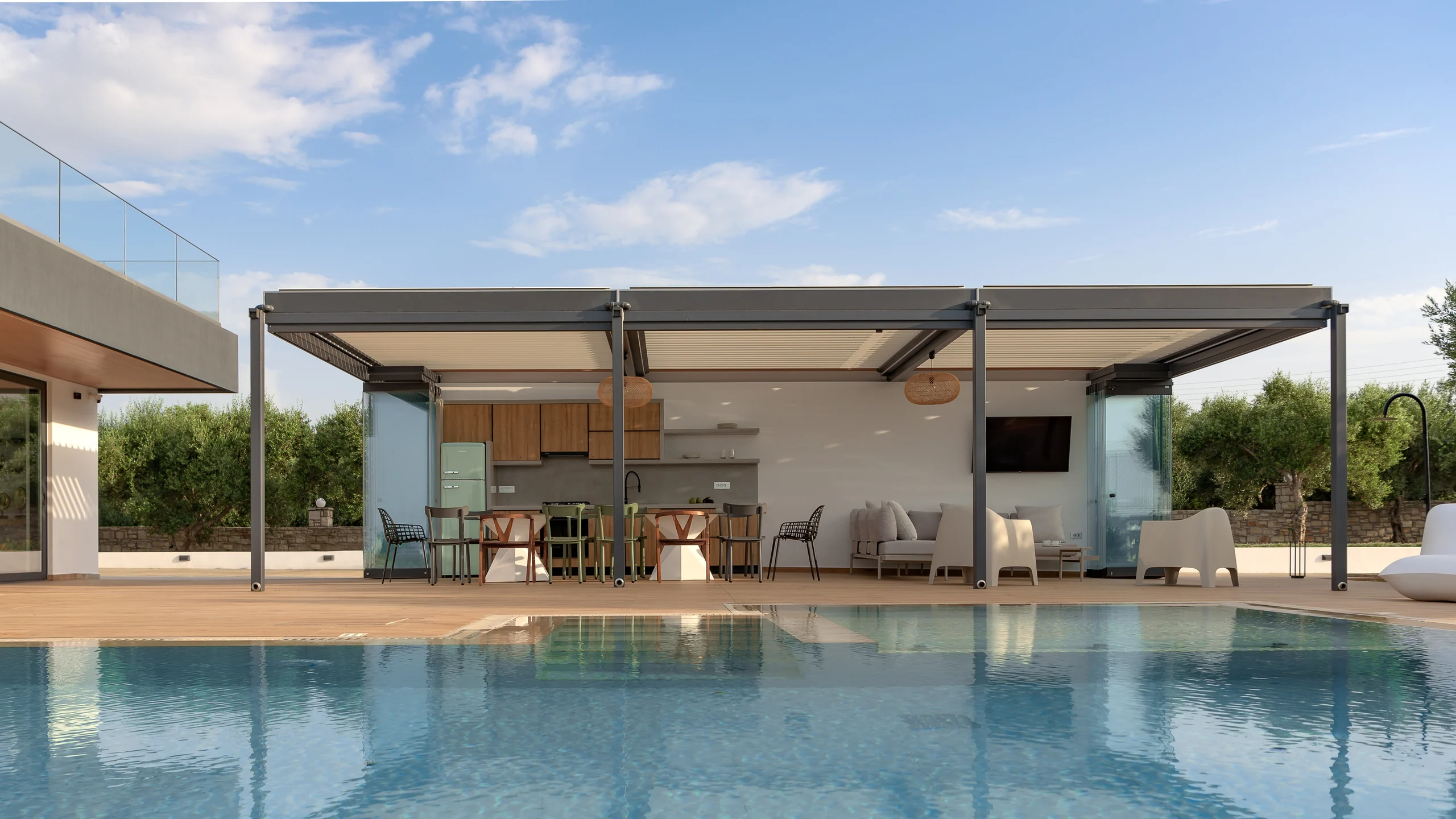 Outdoor kitchen pavilion viewed across the pool at Aesthea Exclusive Villa