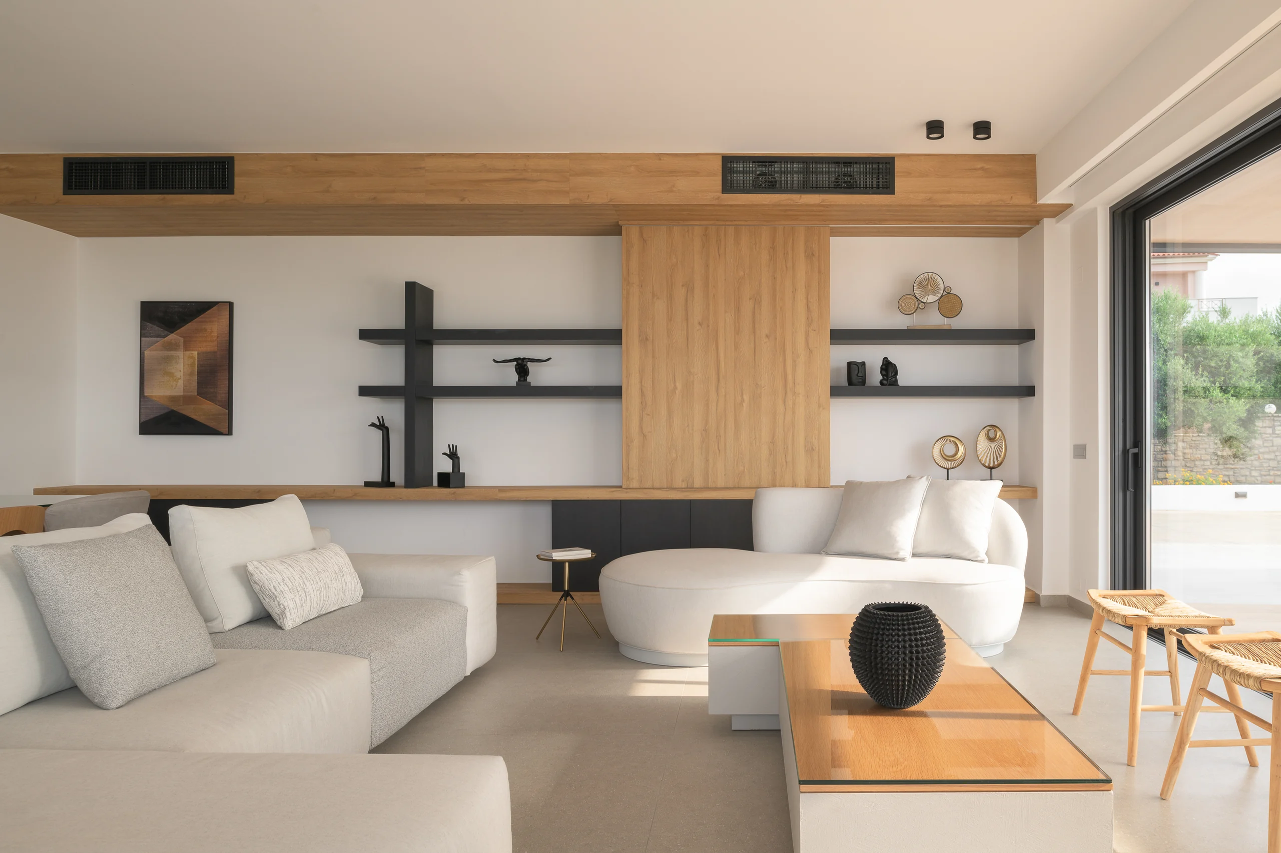 Curved-sofa living room arranged as a cosy place to relax at Aesthea Exclusive Villa