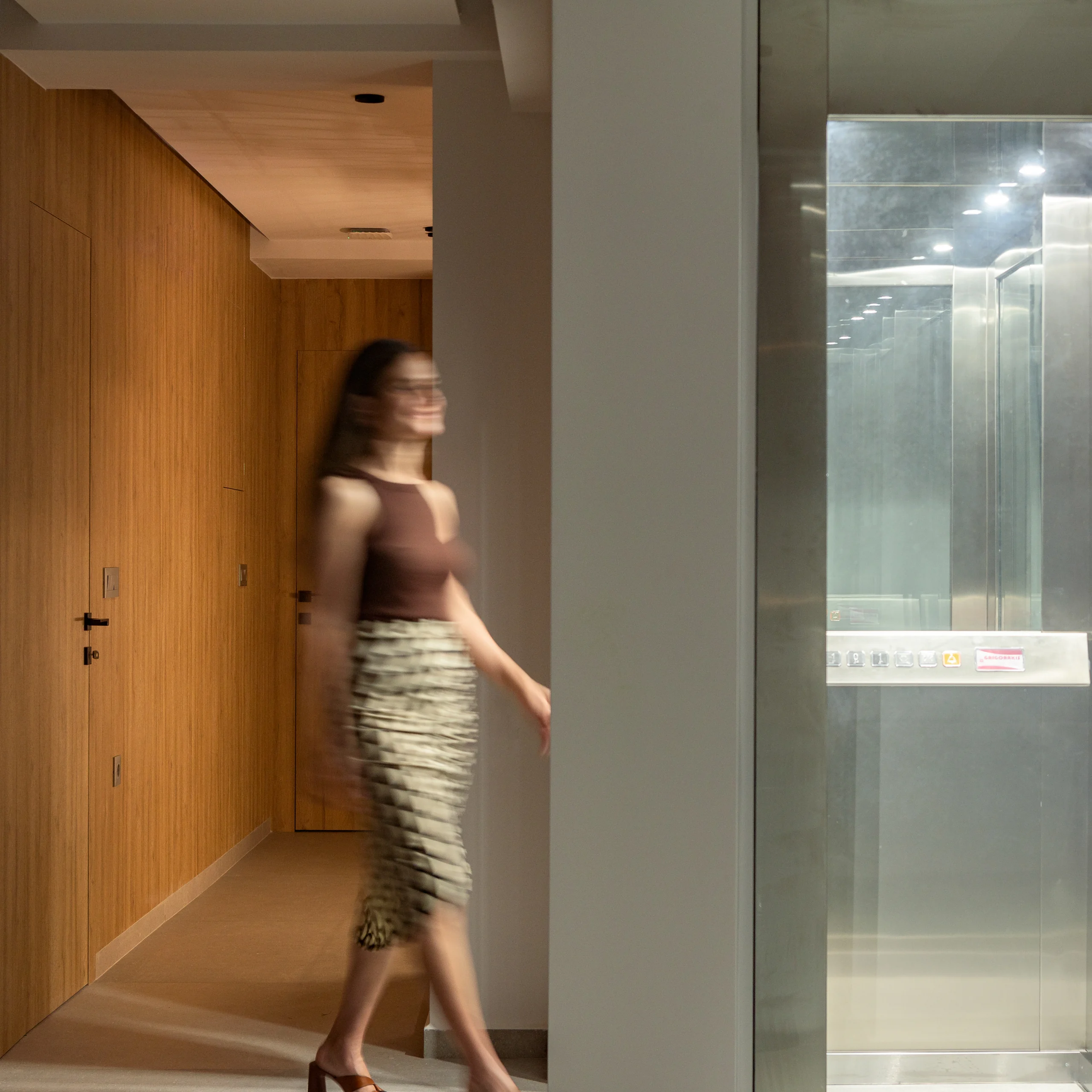 Lower-level corridor leading toward the villa elevator at Aesthea Exclusive Villa