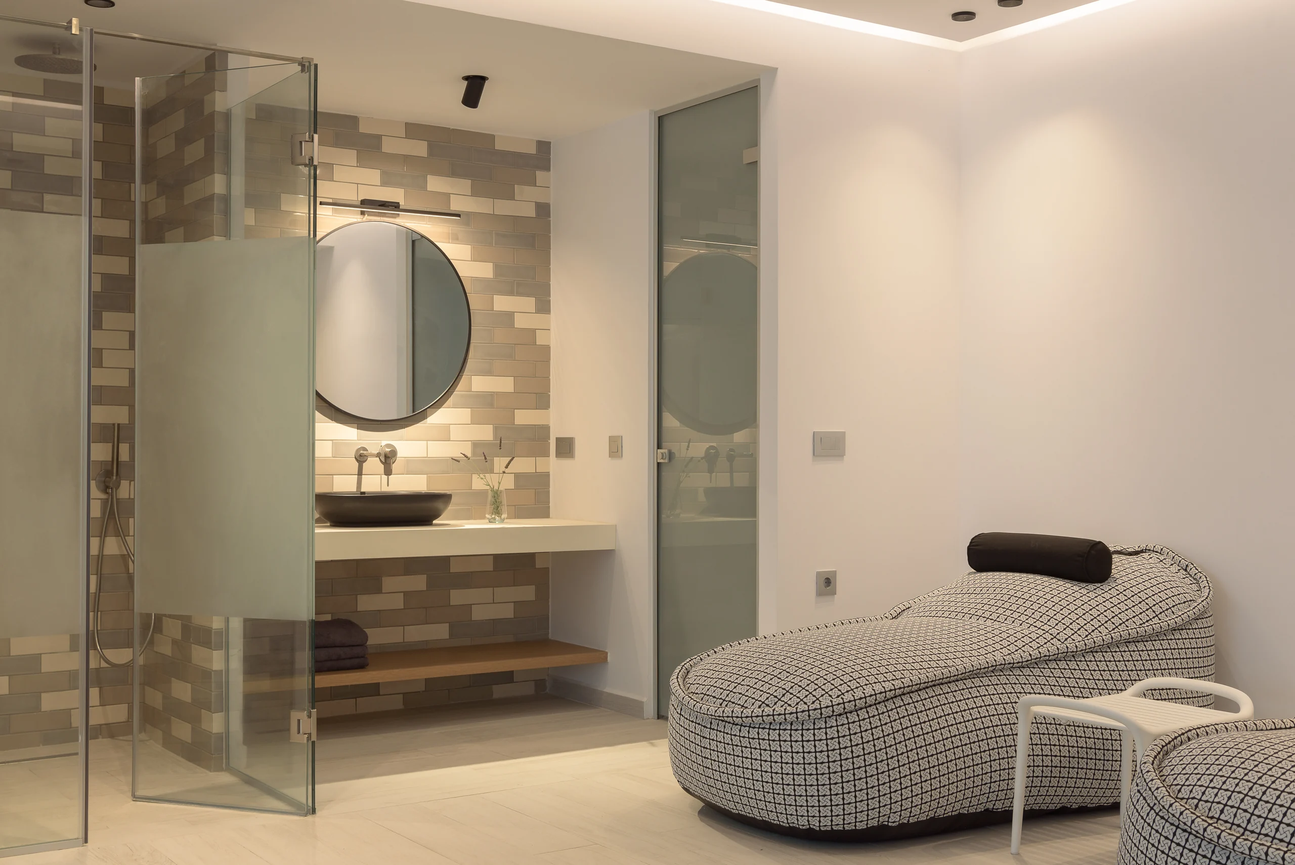 Glass shower and stone vanity beside the indoor pool at Aesthea Exclusive Villa