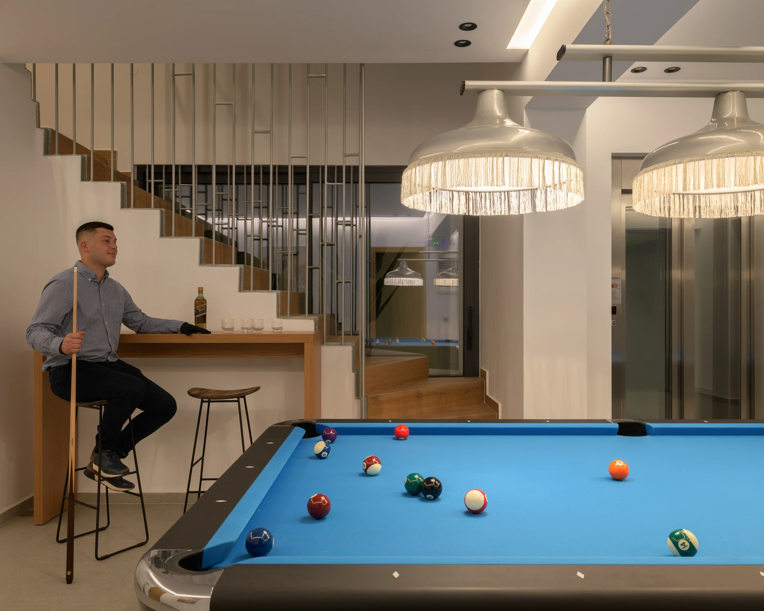 Guest playing billiards beside the lower-level bar at Aesthea Exclusive Villa