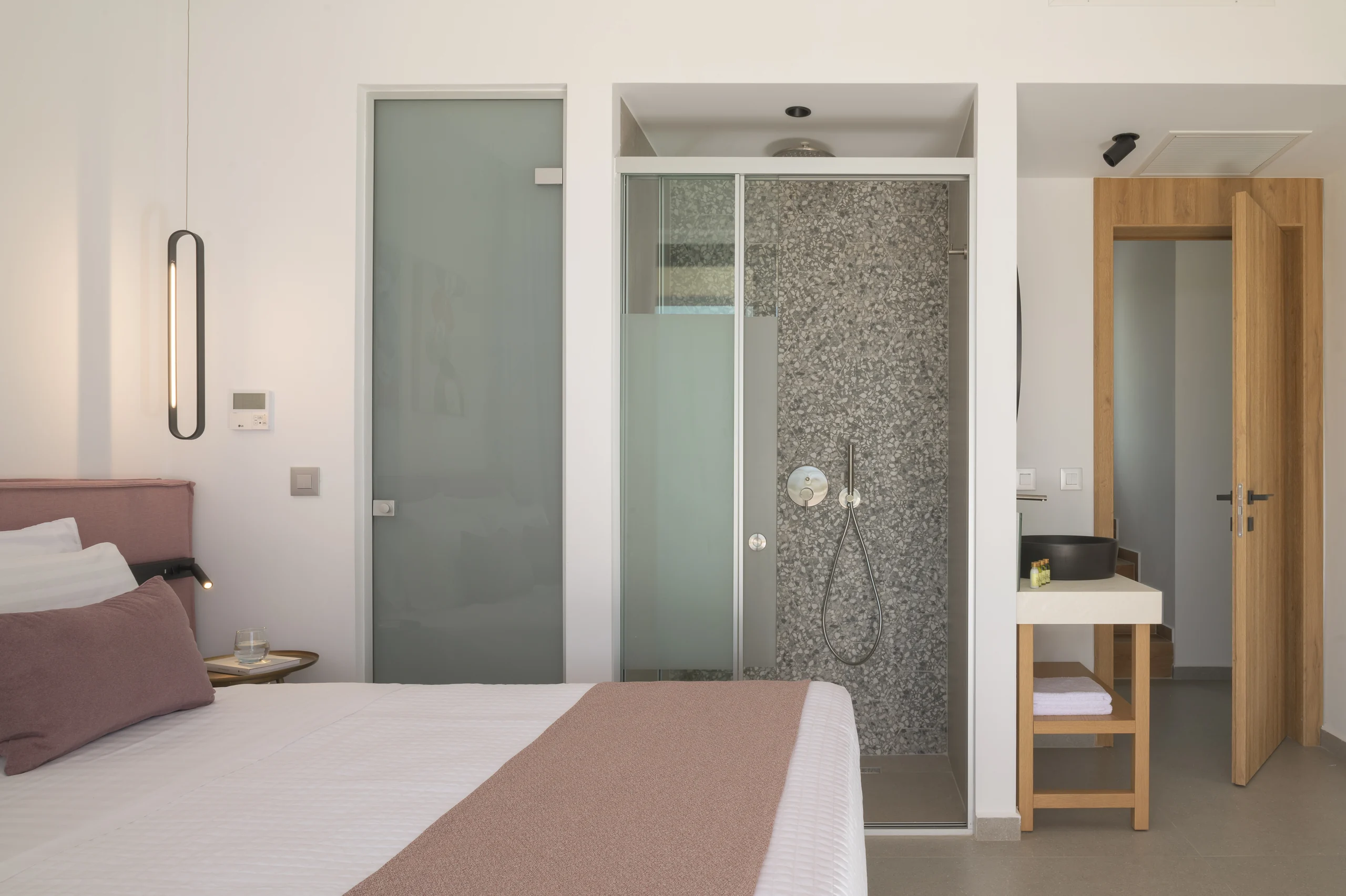 Ground-floor Bedroom 1 with its glass-walled ensuite shower at Aesthea Exclusive Villa