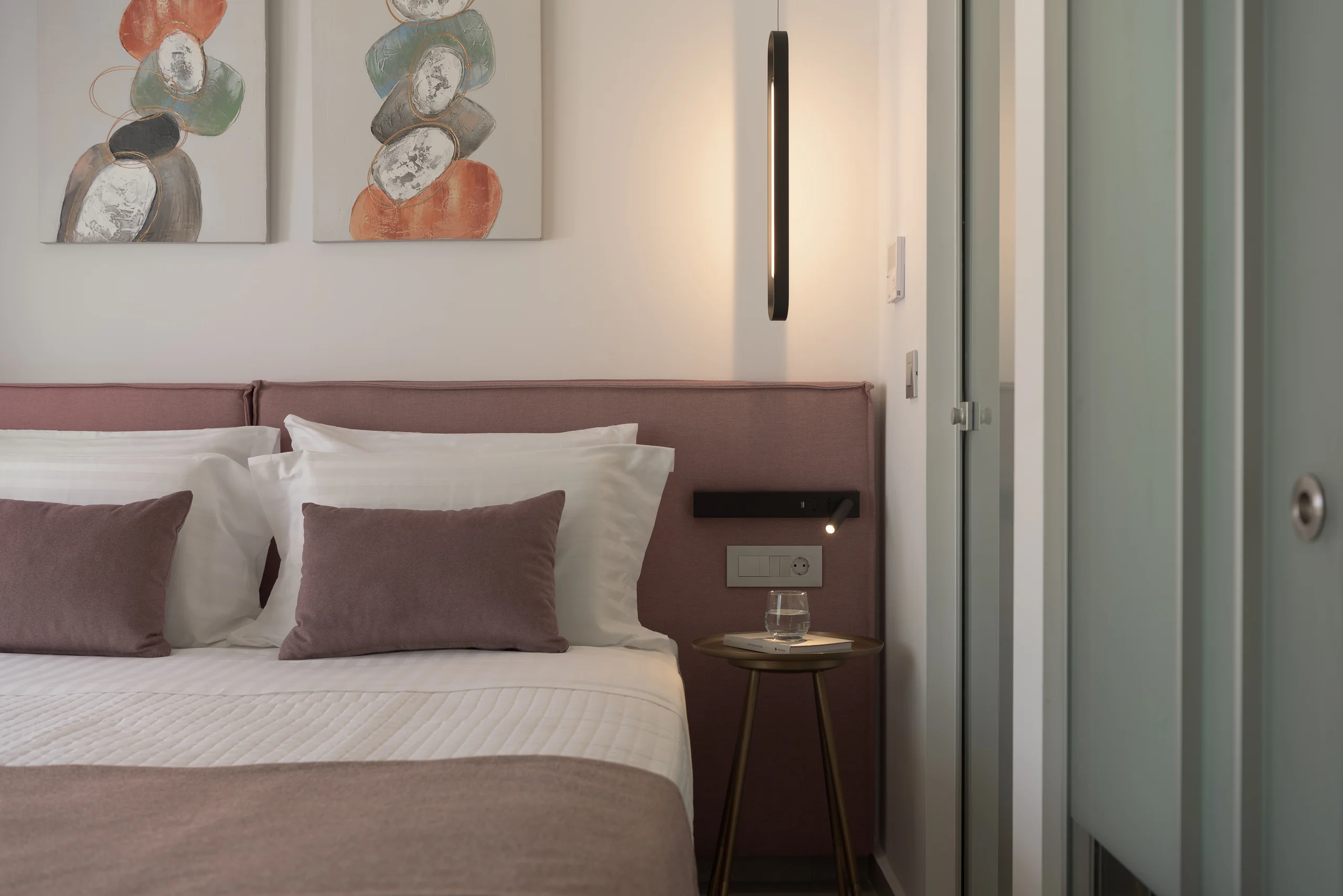 Ground-floor Bedroom 1 with a king bed and plum accents at Aesthea Exclusive Villa