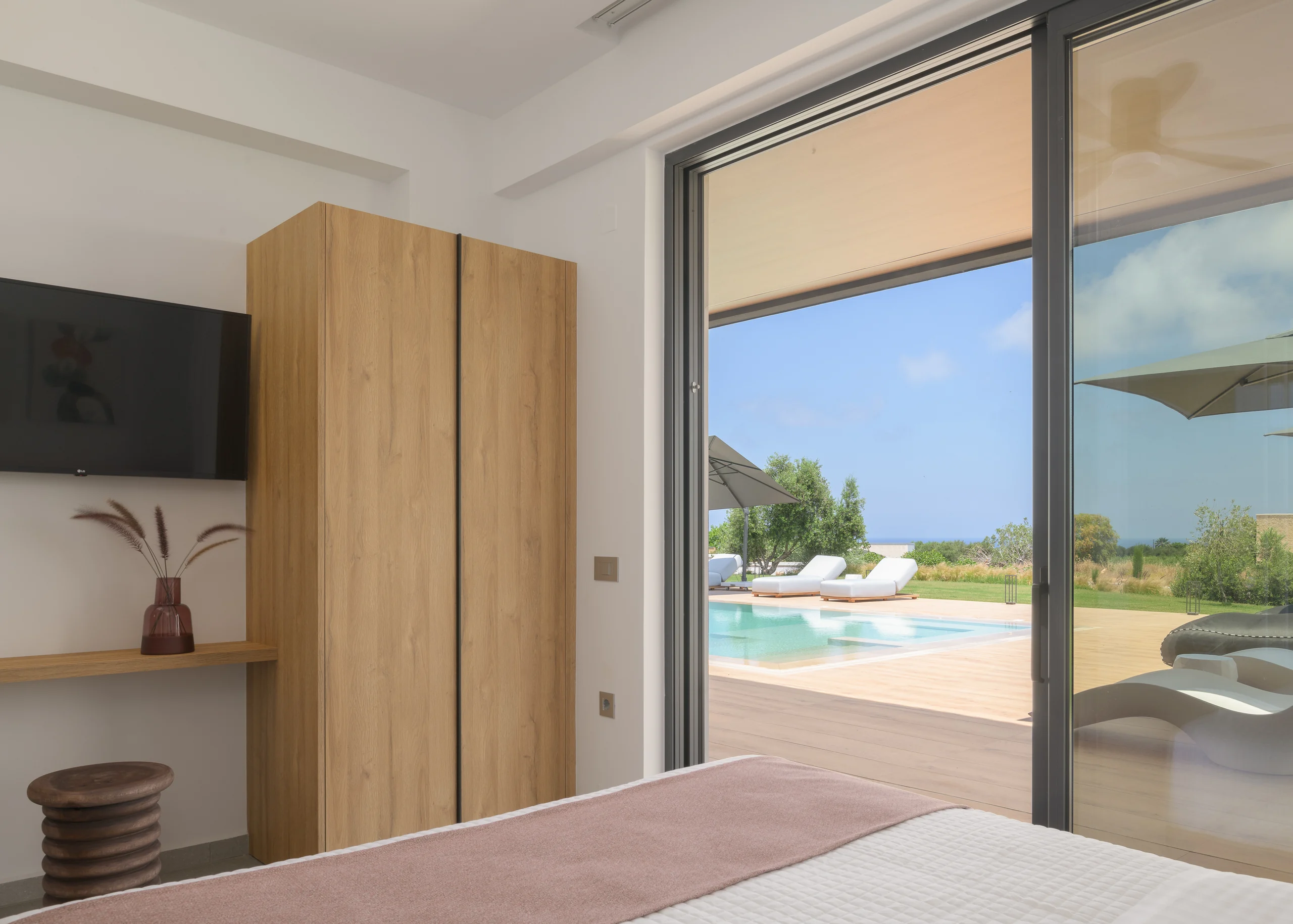 Ground-floor Bedroom 1 opening directly to the outdoor pool at Aesthea Exclusive Villa