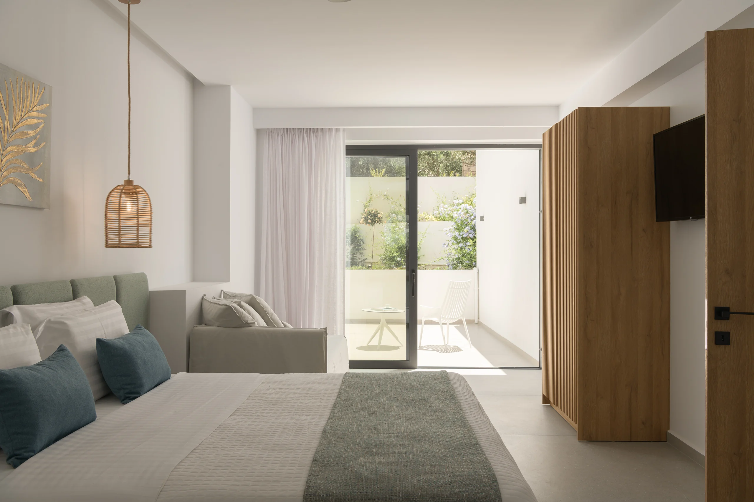 Lower-level bedroom with a split-link king bed and terrace access at Aesthea Exclusive Villa