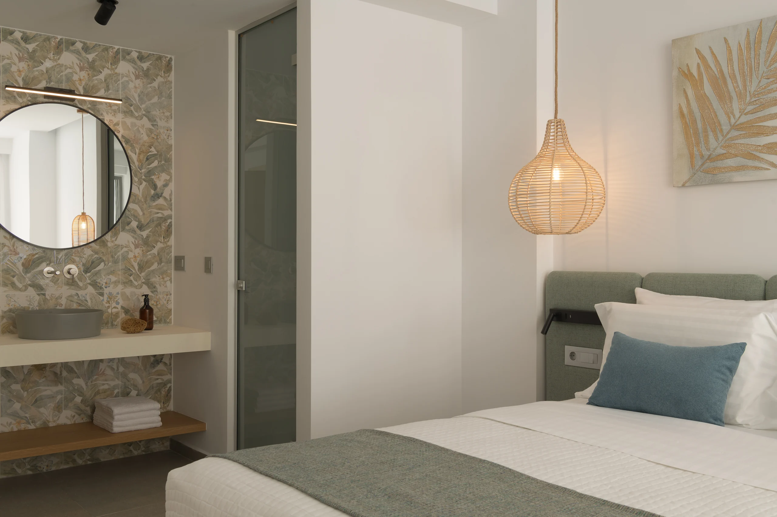 Lower-level bedroom vanity and private ensuite shower at Aesthea Exclusive Villa