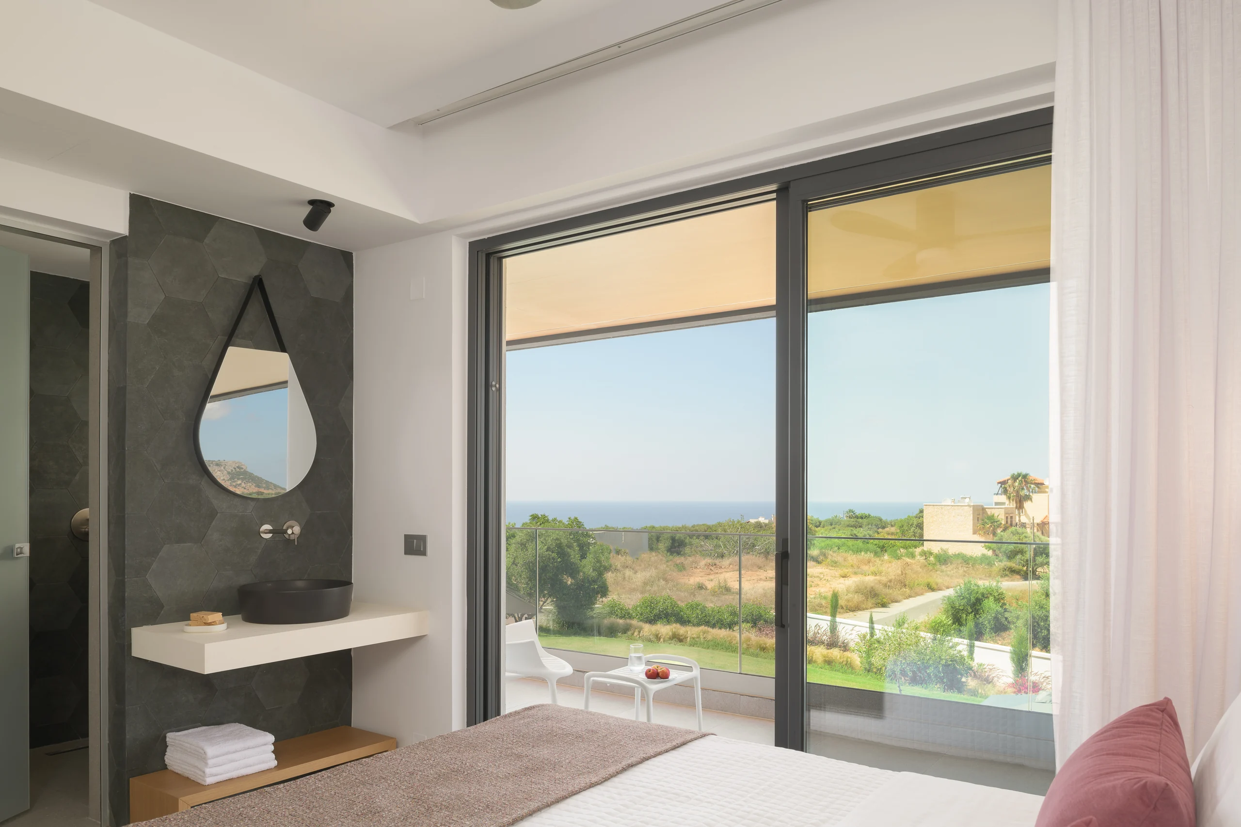 Vanity and glazed doors opening to the balcony of First-floor Bedroom 1 at Aesthea Exclusive Villa