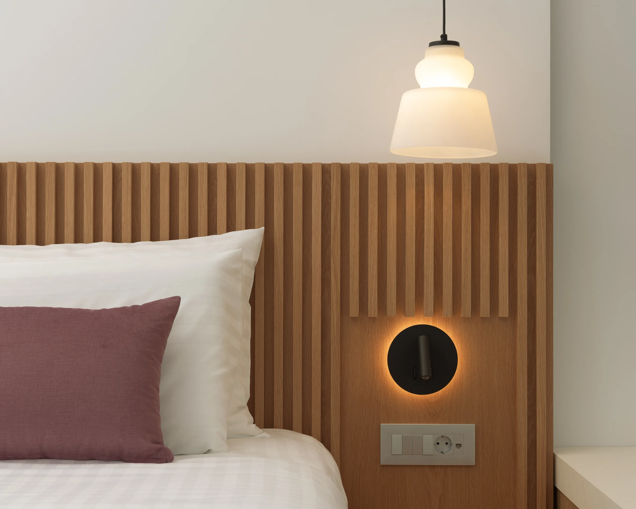 Timber headboard and integrated reading light in First-floor Bedroom 1 at Aesthea Exclusive Villa