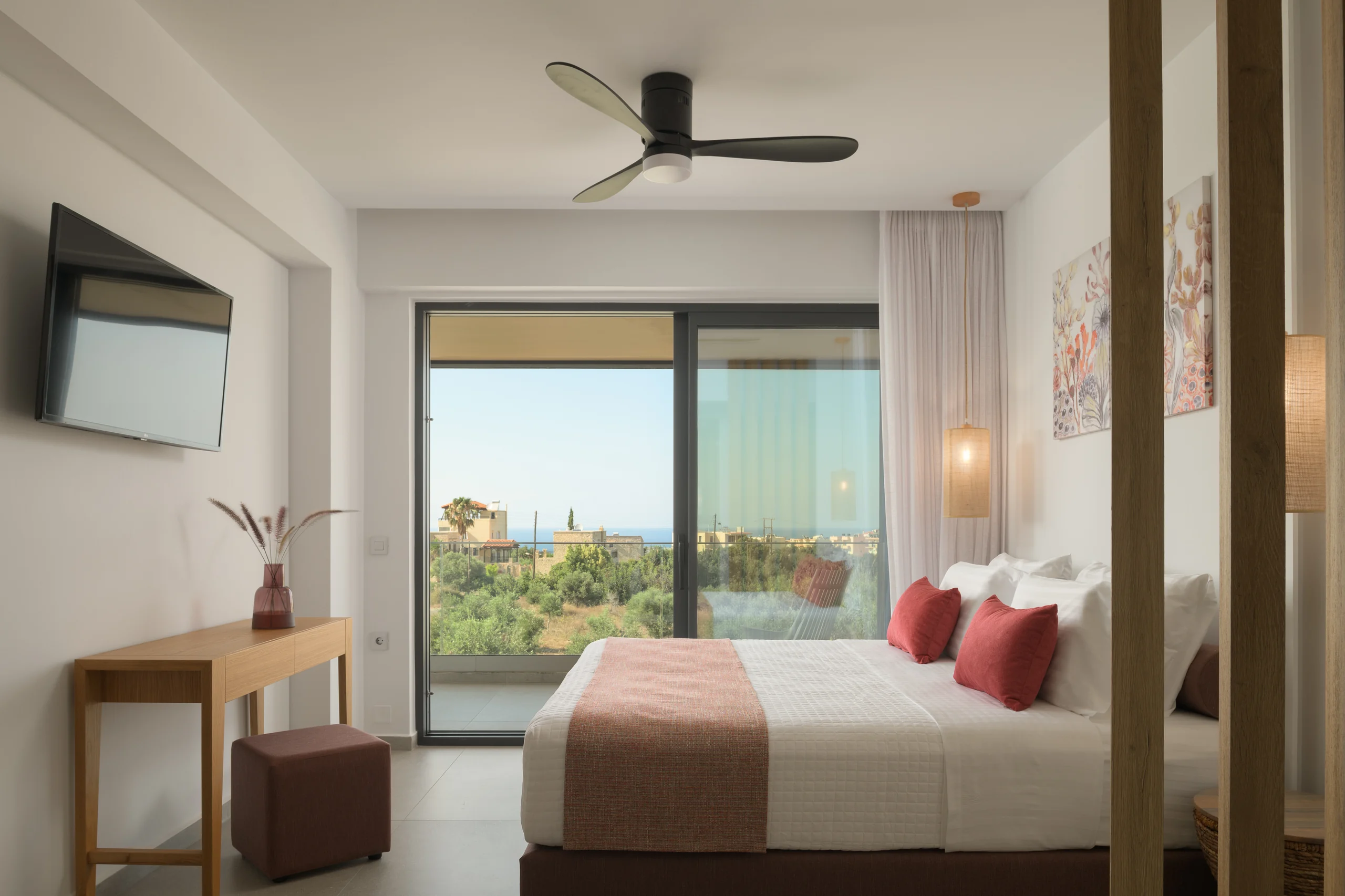 Light-filled First-floor Bedroom 3 with a queen bed and coral accents at Aesthea Exclusive Villa