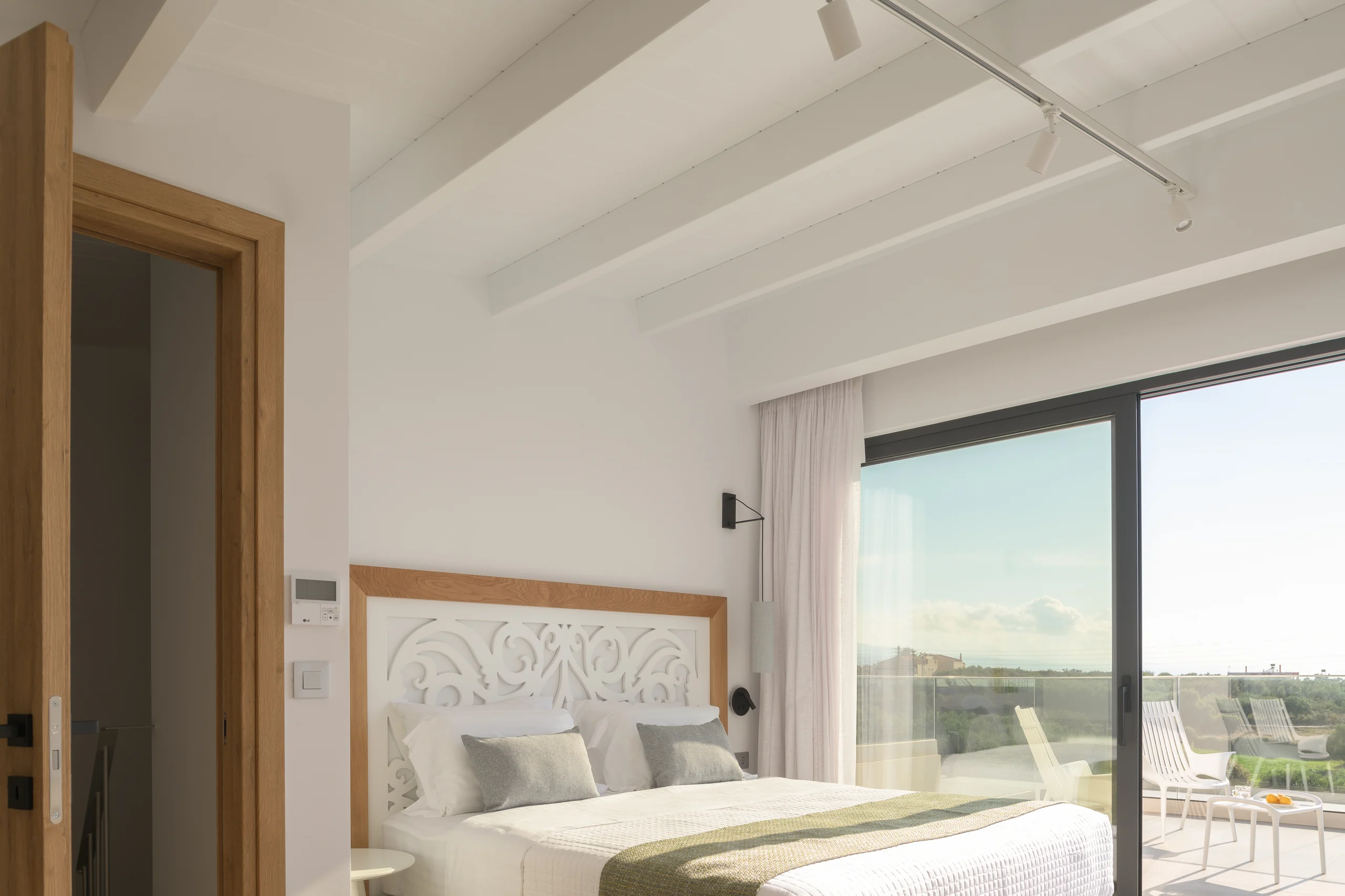 Upper-level loft bedroom with a king bed and private view terrace at Aesthea Exclusive Villa