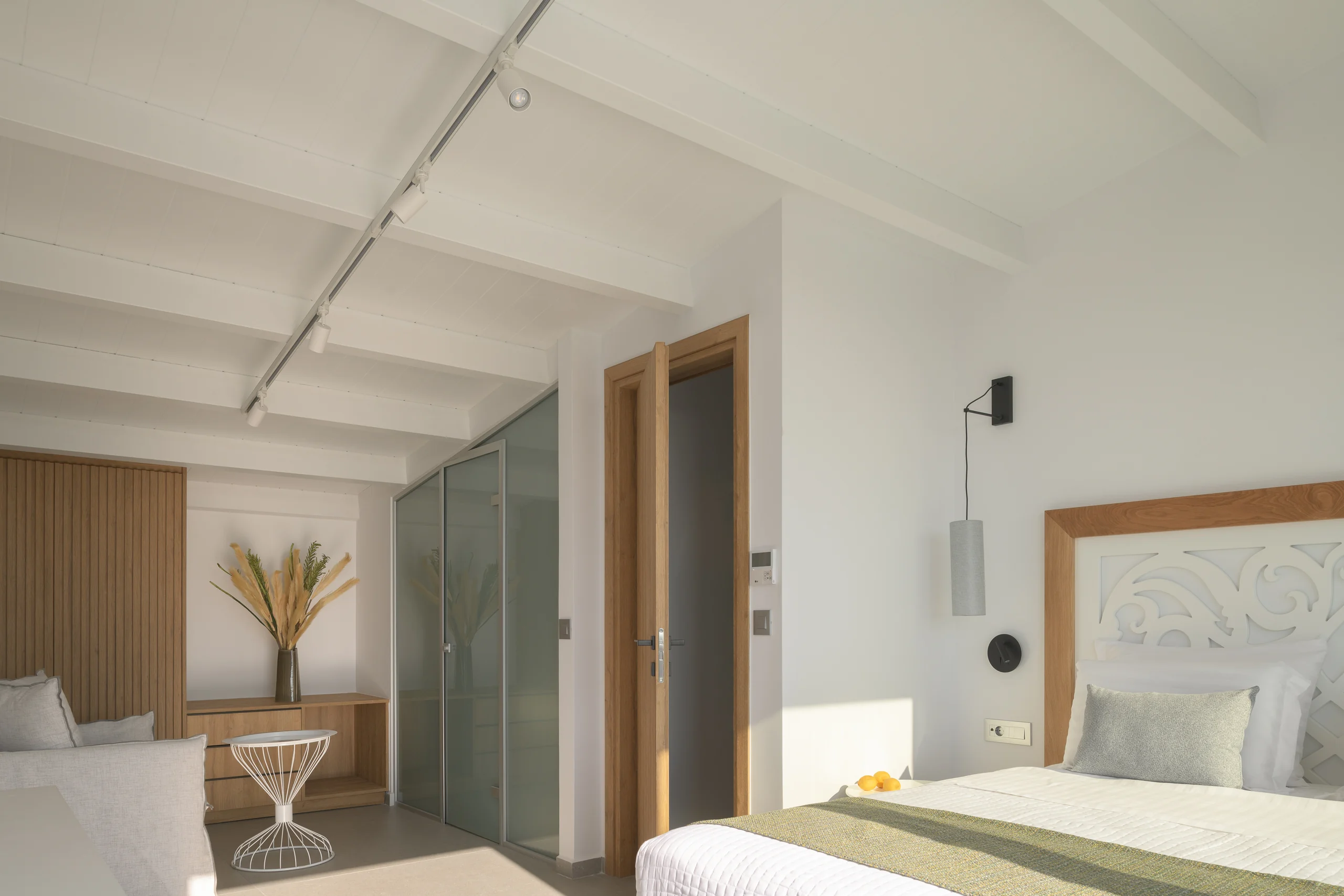 King bed and sofa-bed seating in the upper-level loft bedroom at Aesthea Exclusive Villa