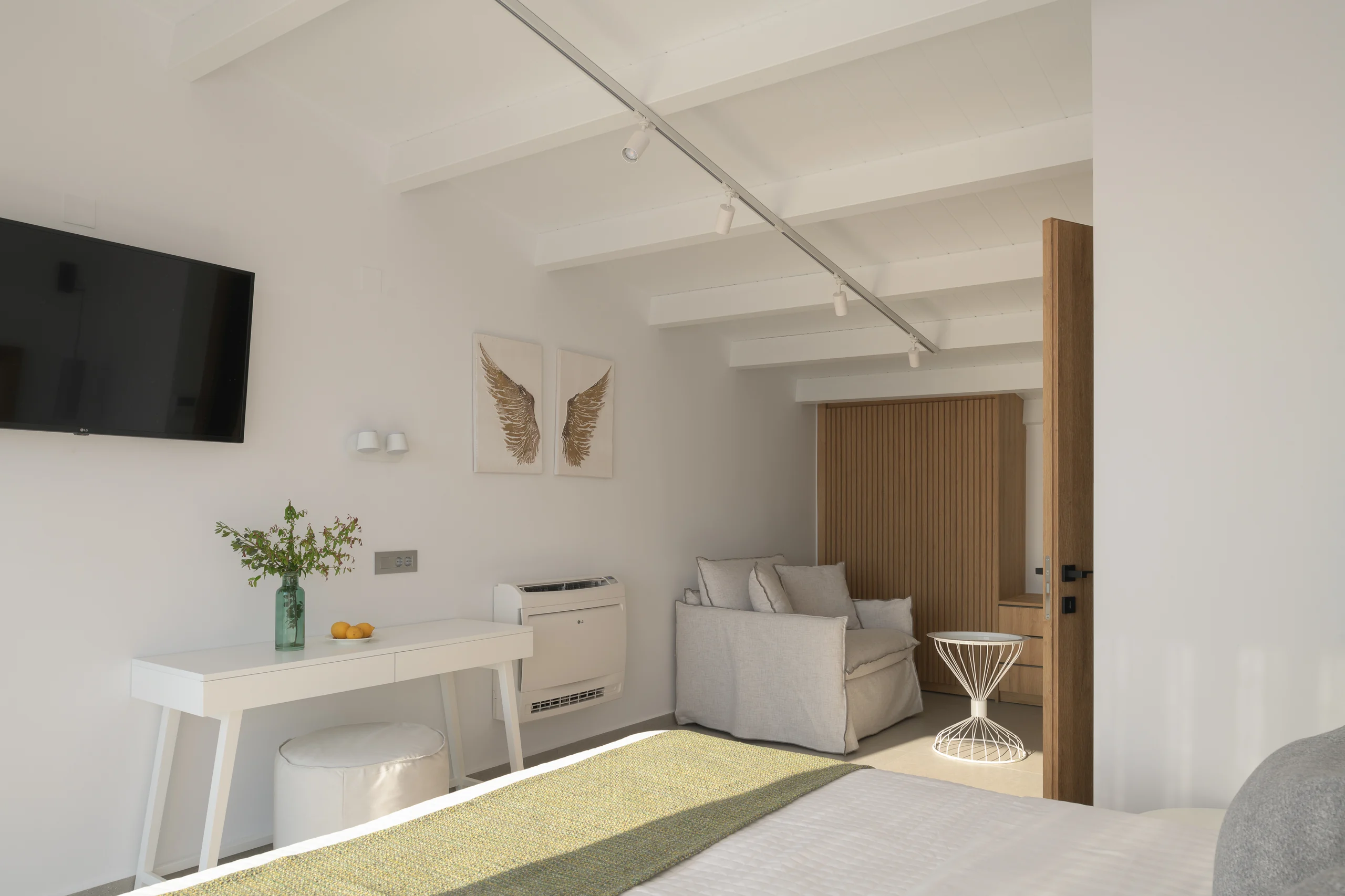 Desk and lounge area in the upper-level loft bedroom at Aesthea Exclusive Villa
