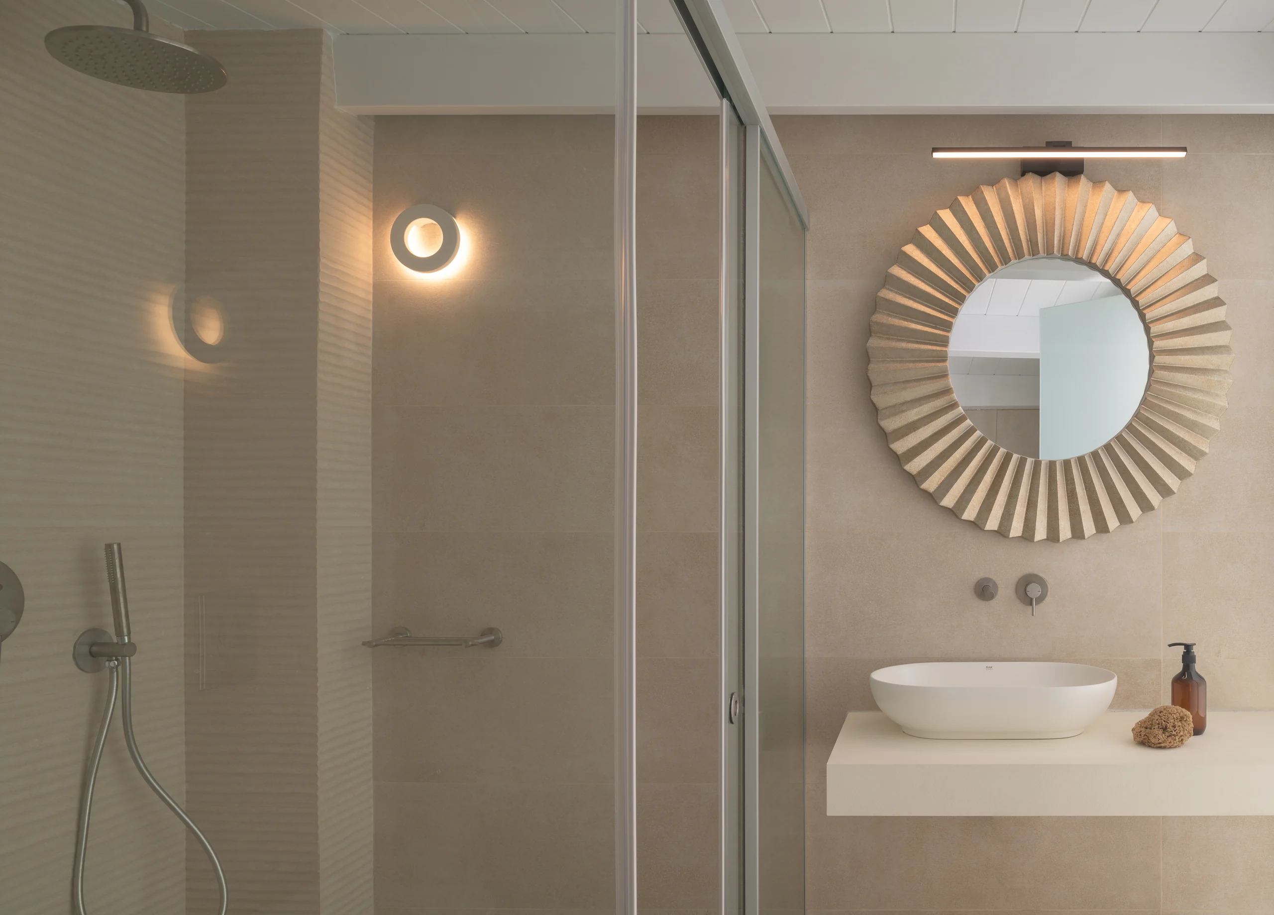 Private shower and round-mirror vanity in the upper-level loft bedroom at Aesthea Exclusive Villa