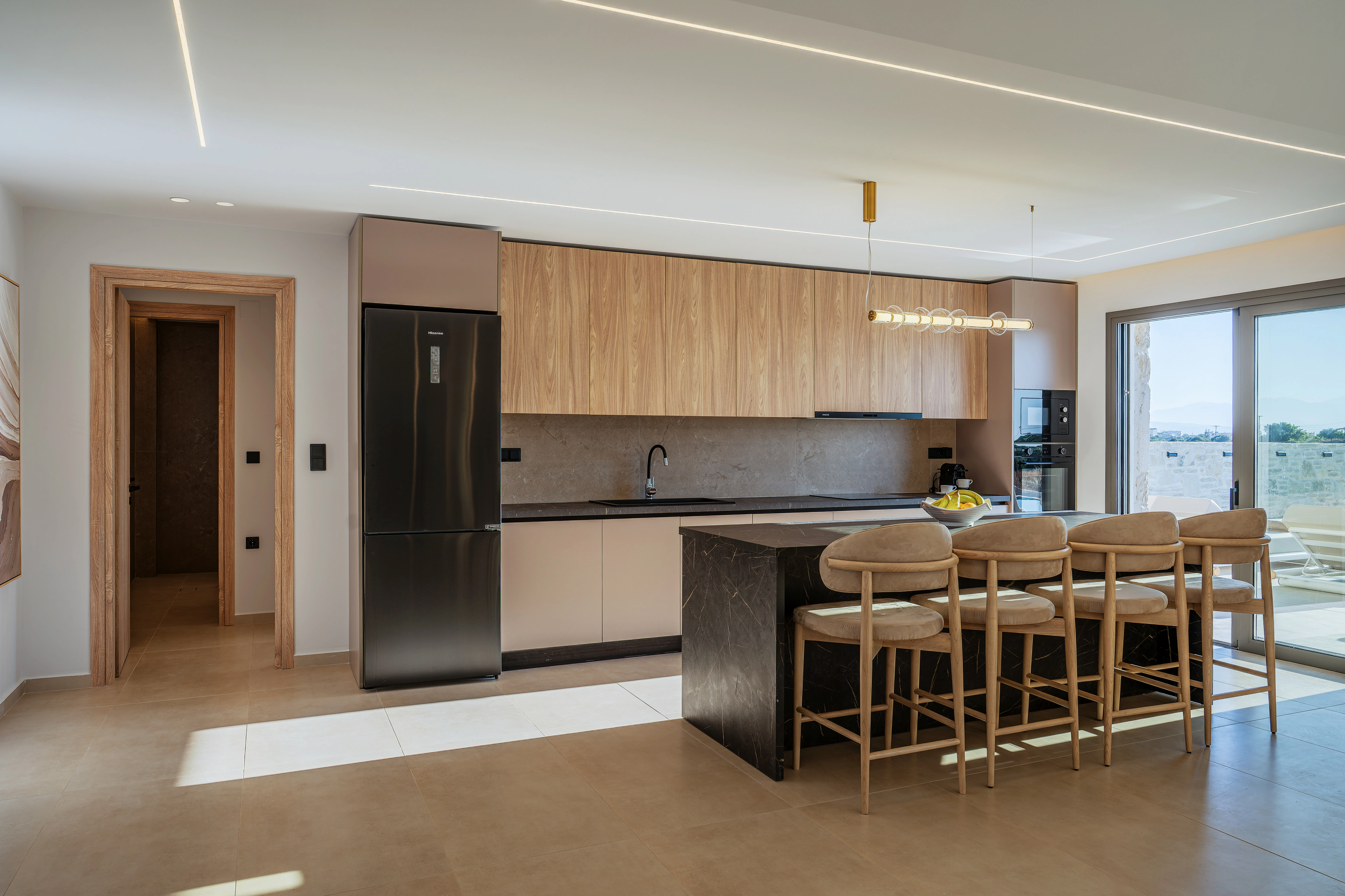 Right Crete kitchen and dining room with pale timber cabinetry
