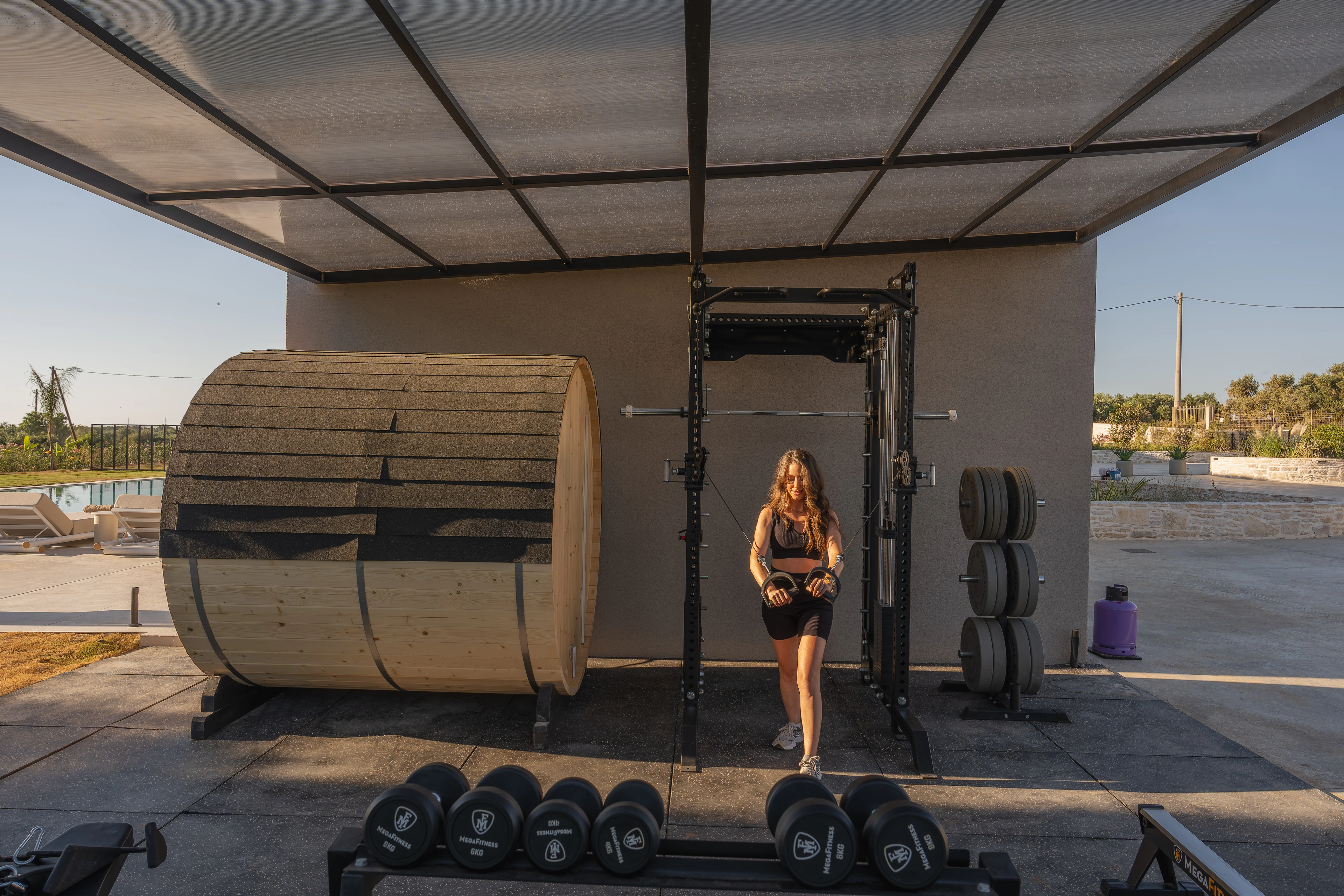 Left Crete private outdoor gym with free weights and training rack