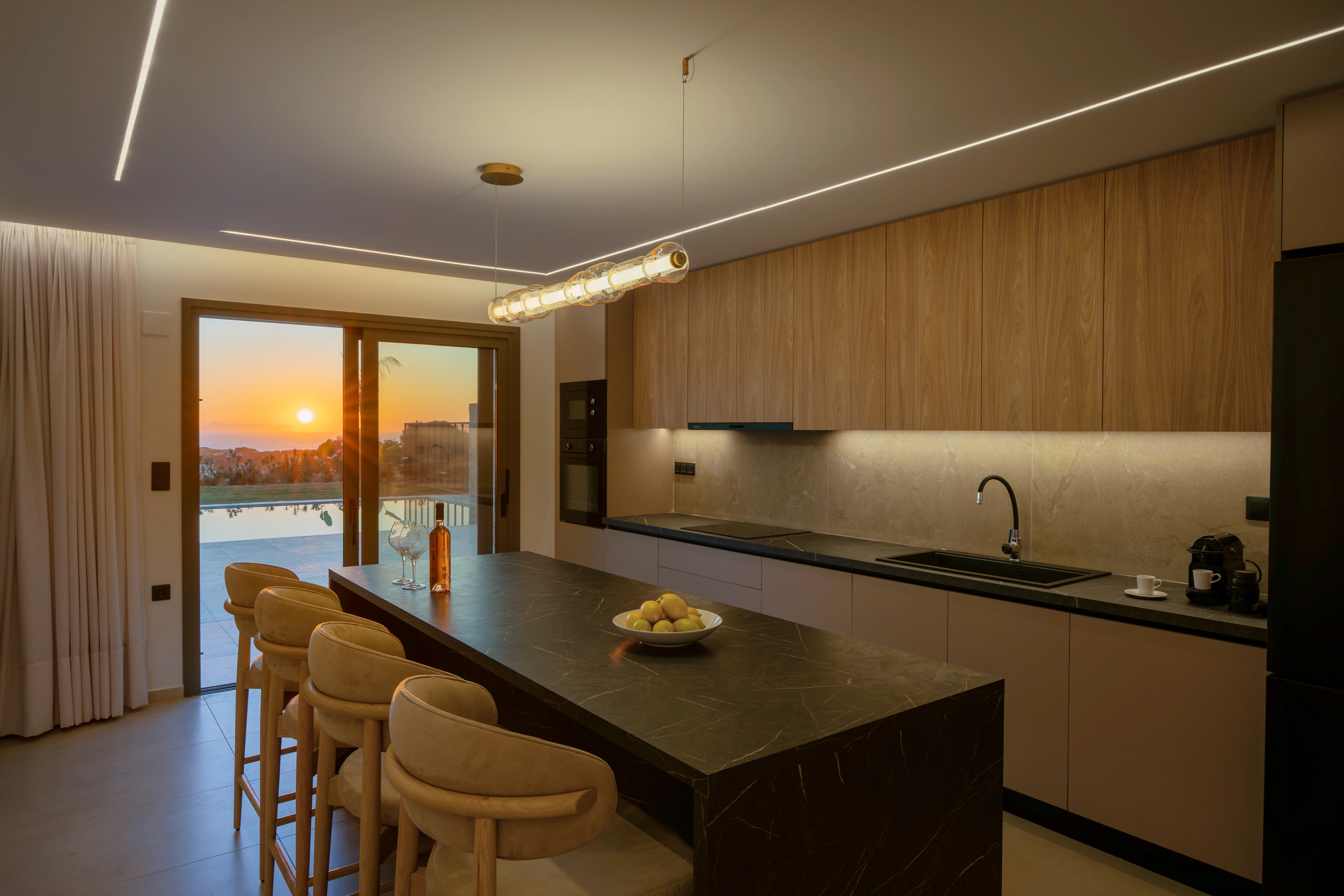 Left Crete kitchen and dining area with stone and timber finishes