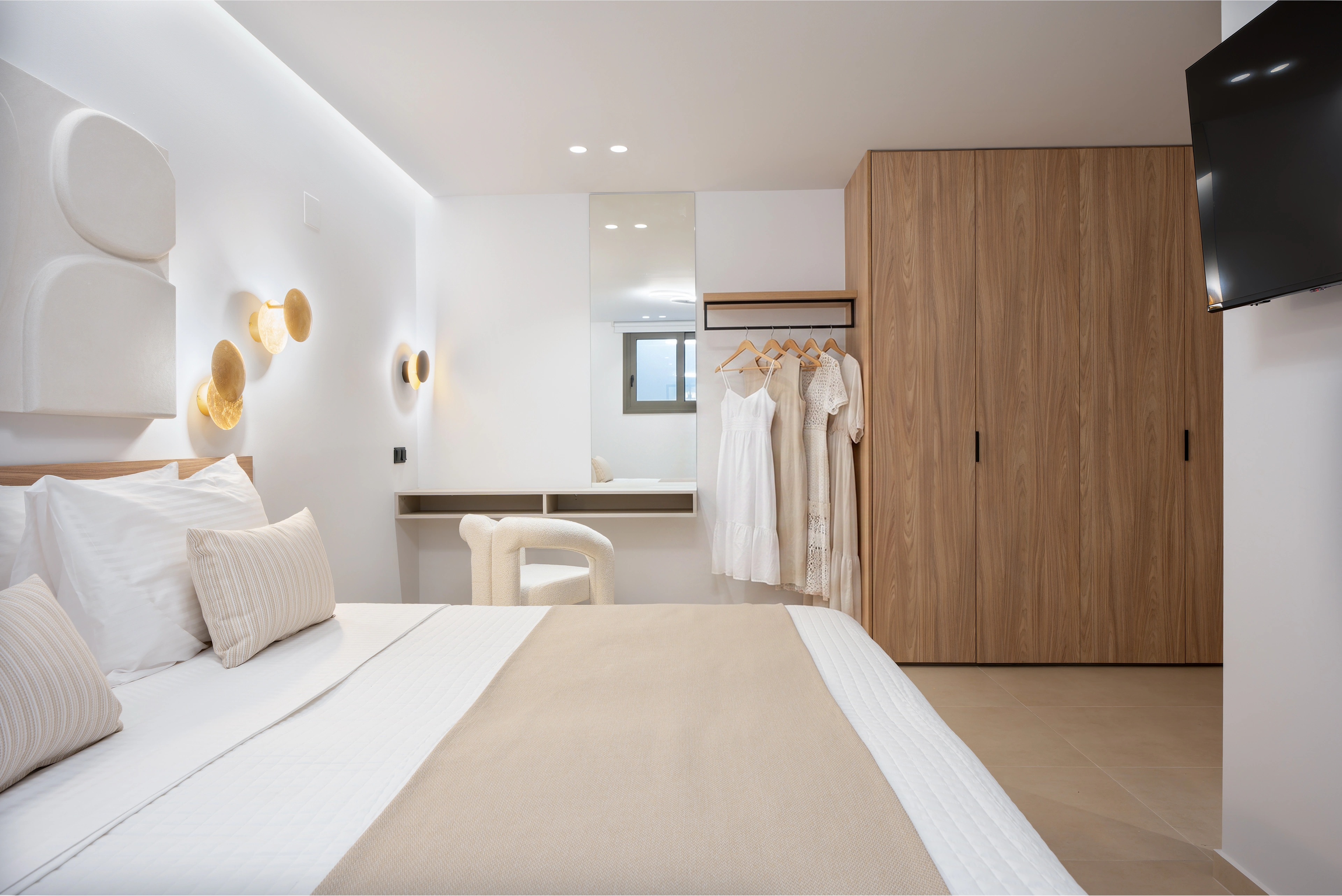 Left Crete bedroom 01 with a king-size bed, timber wardrobe and dressing area