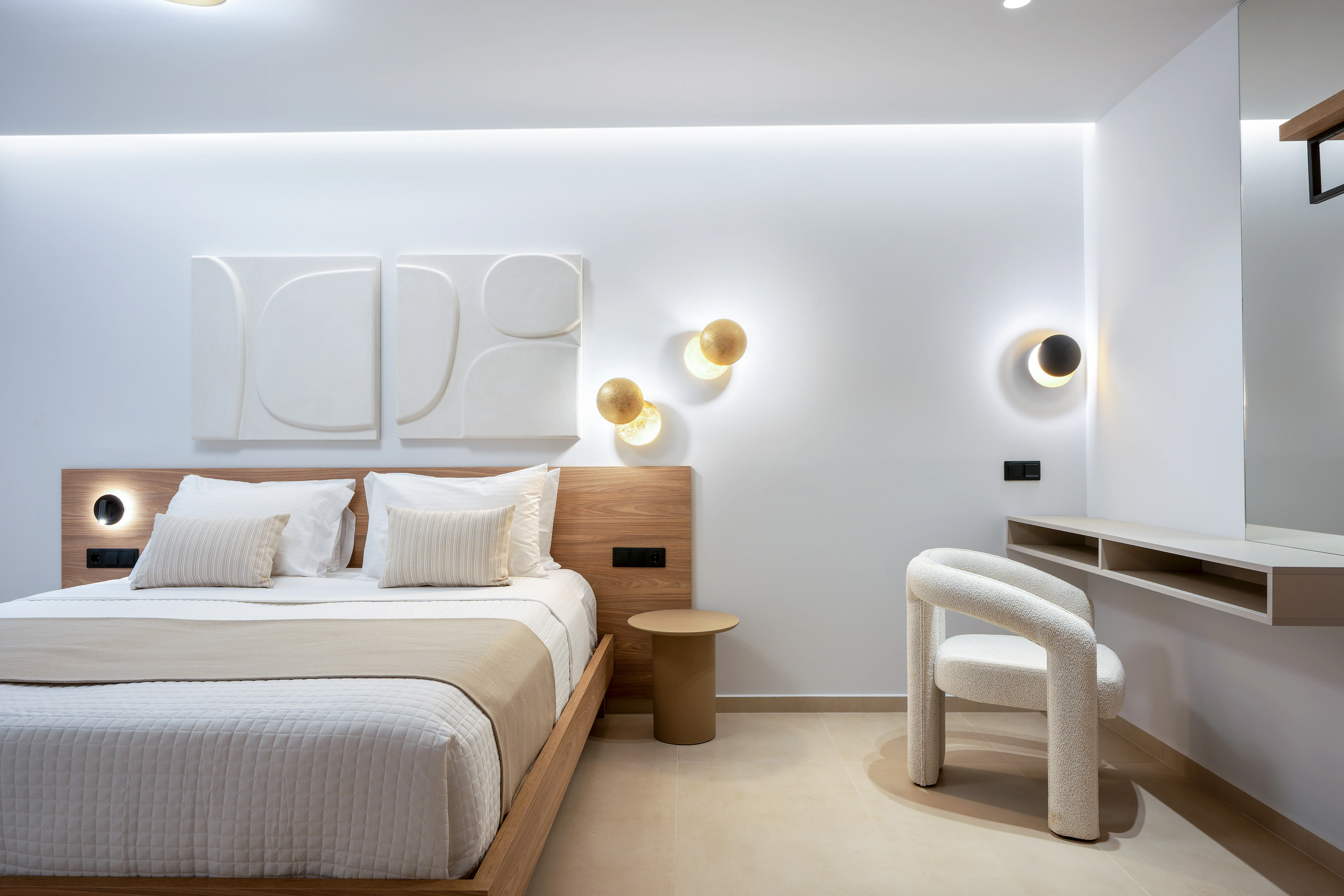 Front view of the king-size bed and softly illuminated headboard in Left Crete bedroom 01