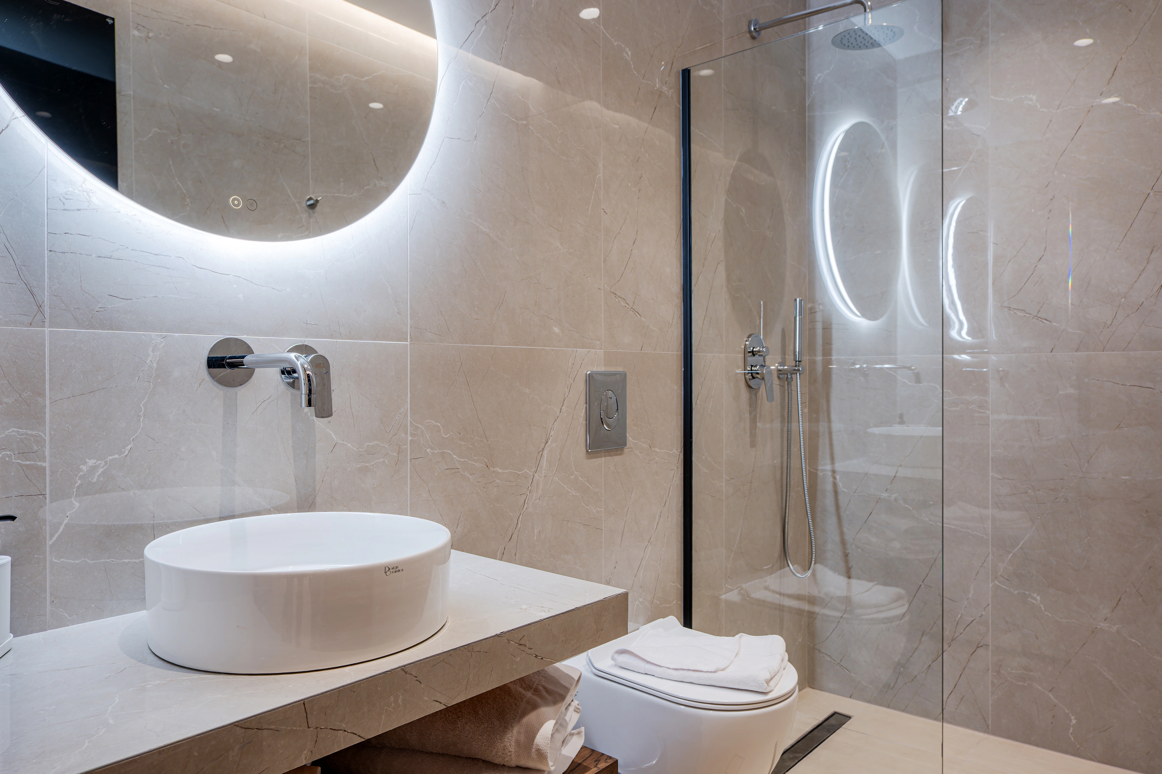 Private en-suite bathroom for Left Crete bedroom 01 with stone vanity and walk-in shower