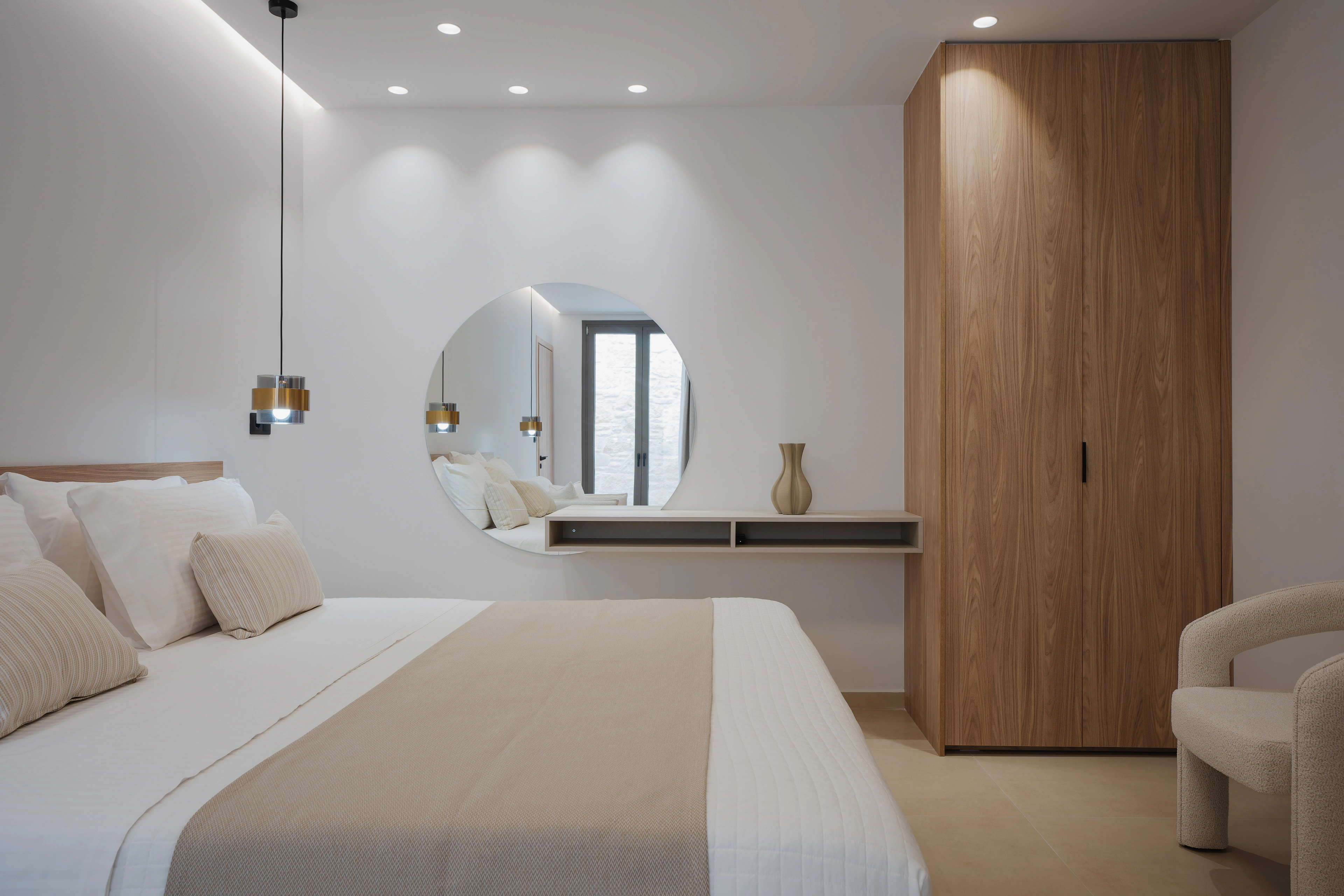 Left Crete bedroom 02 with a king-size bed, pendant lights and timber wardrobe
