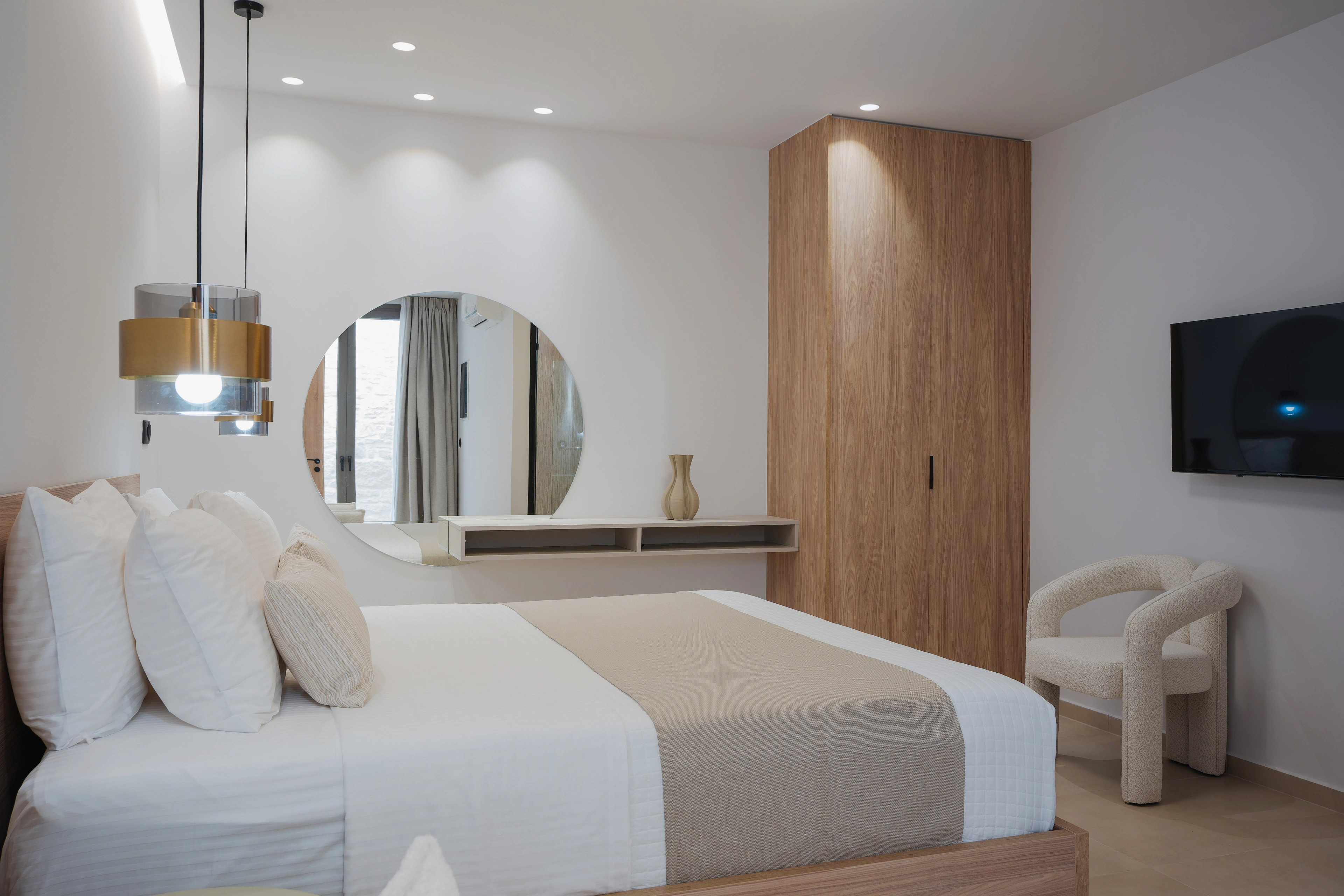Wide view of Left Crete bedroom 02 with its king-size bed, wardrobe and dressing area