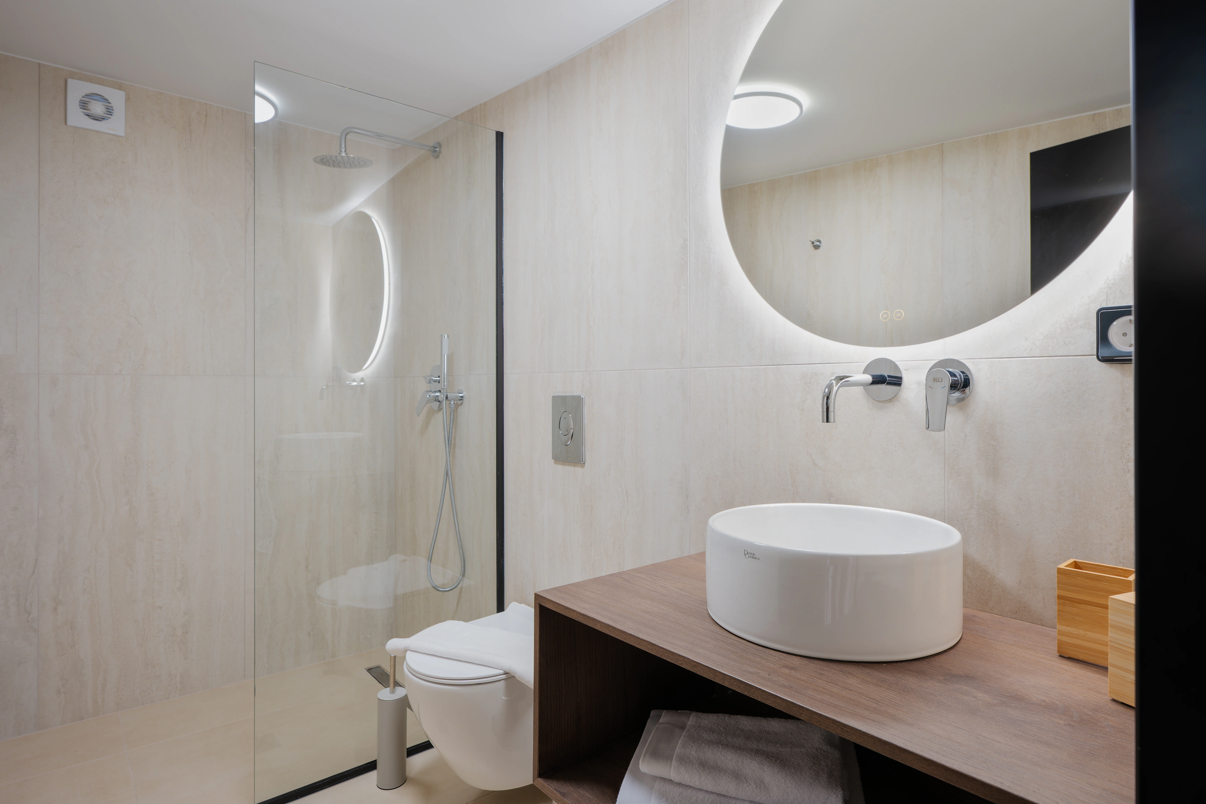 Private en-suite bathroom for Left Crete bedroom 03 with pale stone vanity and shower