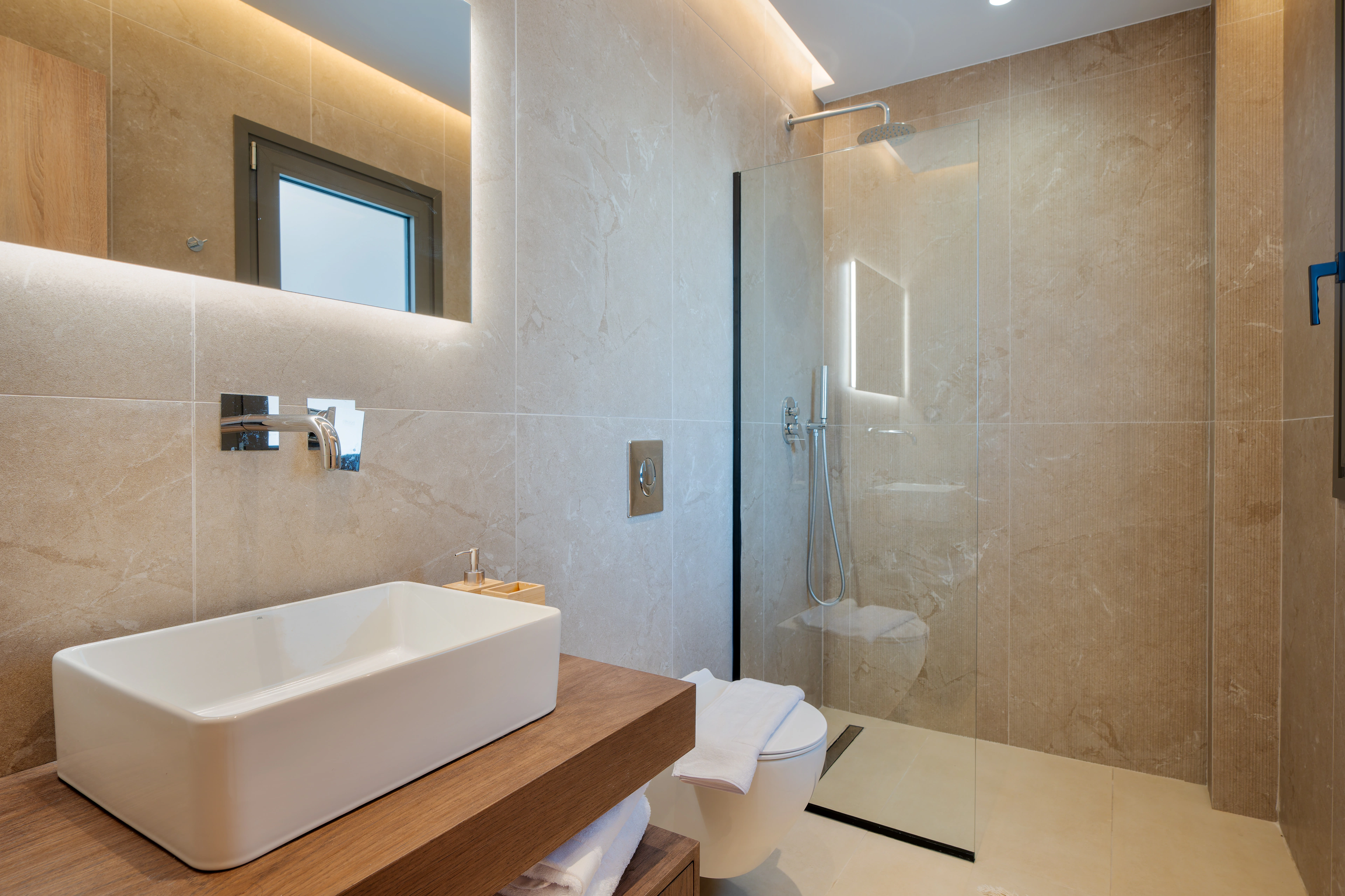 Private en-suite bathroom for Left Crete bedroom 05 with stone vanity and walk-in shower
