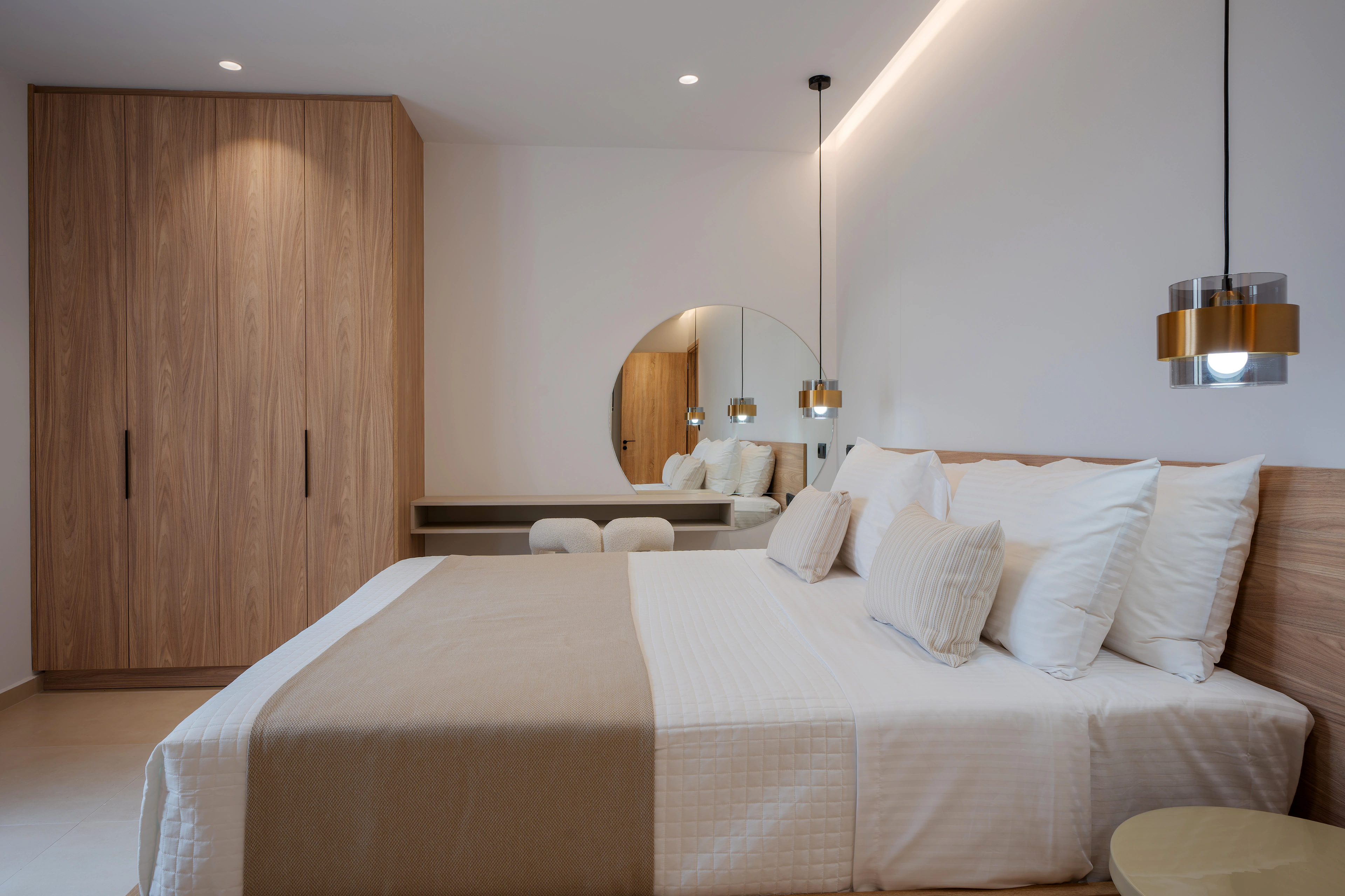 Right Crete bedroom 01 with a king-size bed, timber wardrobe and pendant lights