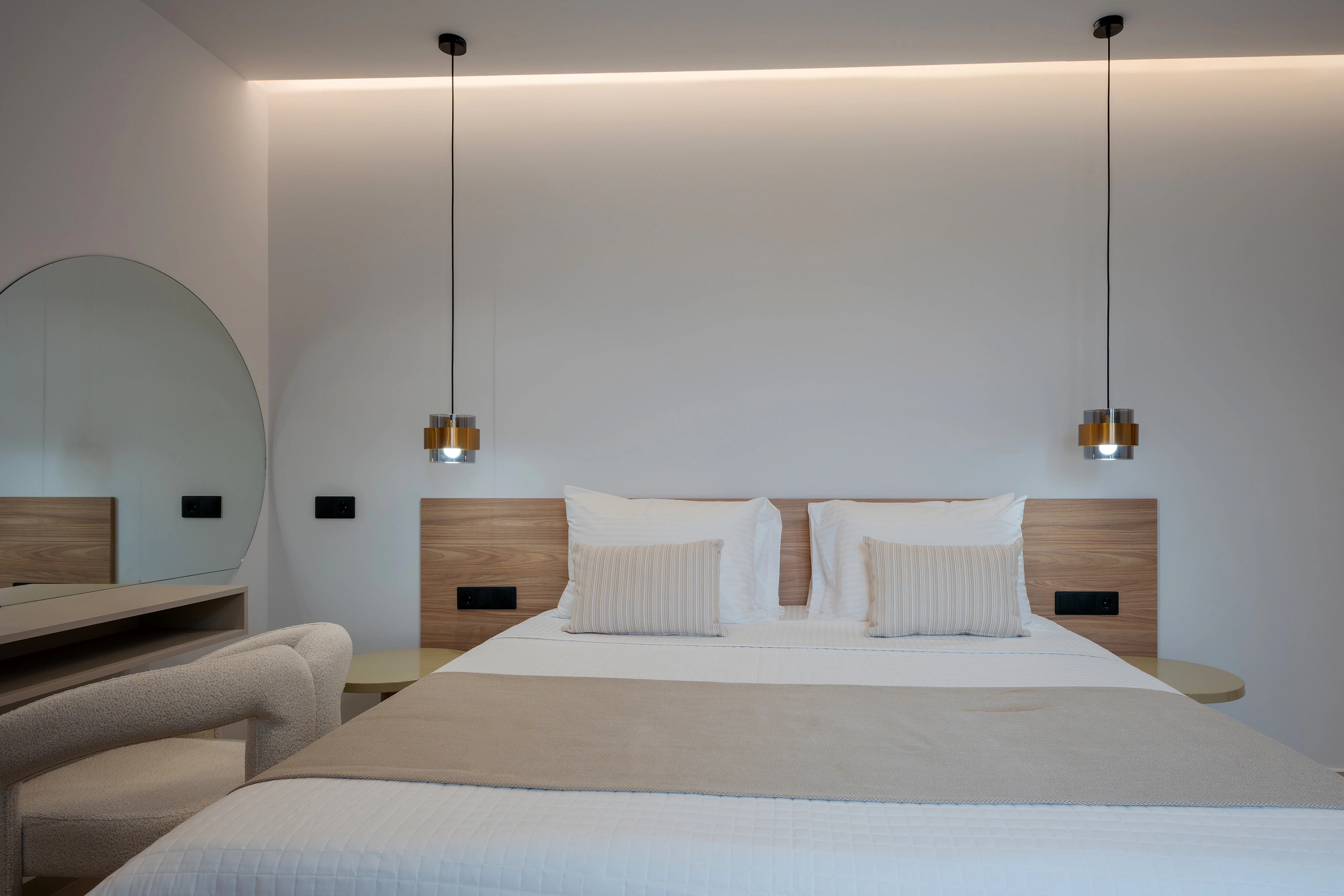 Front view of the king-size bed and softly lit headboard in Right Crete bedroom 01