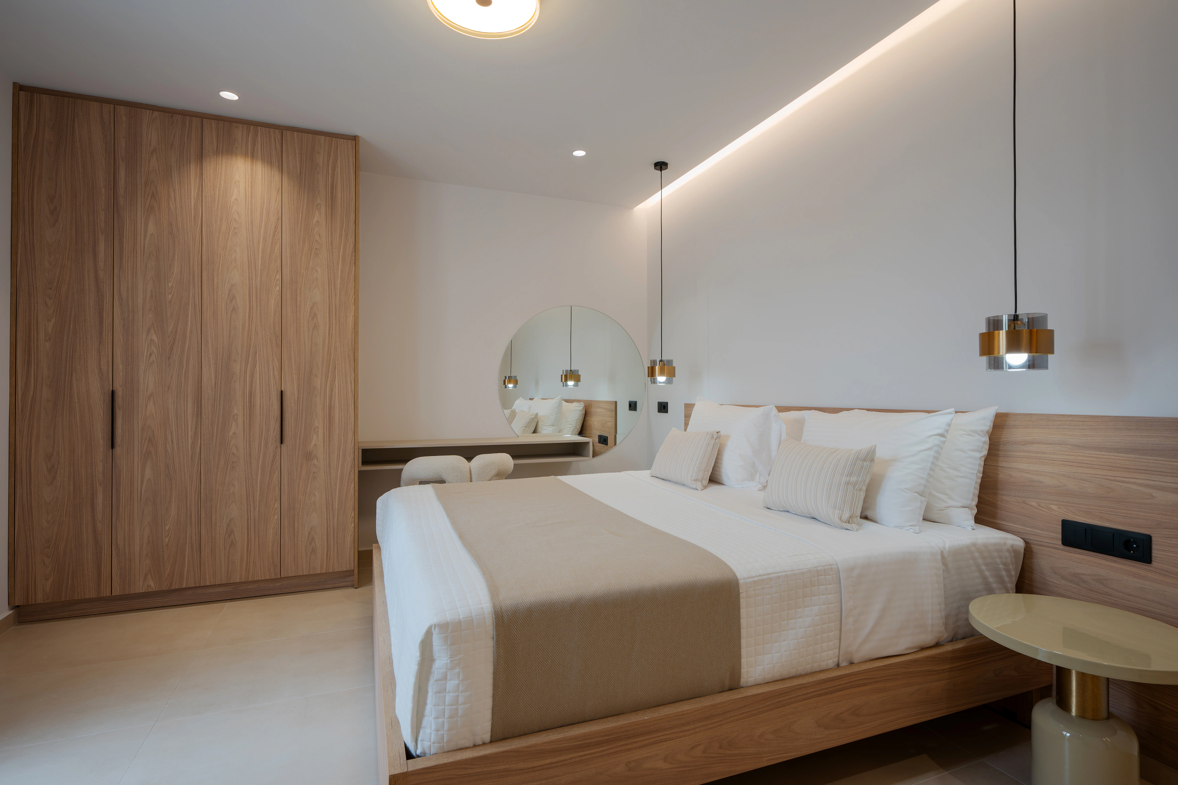 Wide view of Right Crete bedroom 01 with its king-size bed, wardrobe and dressing mirror