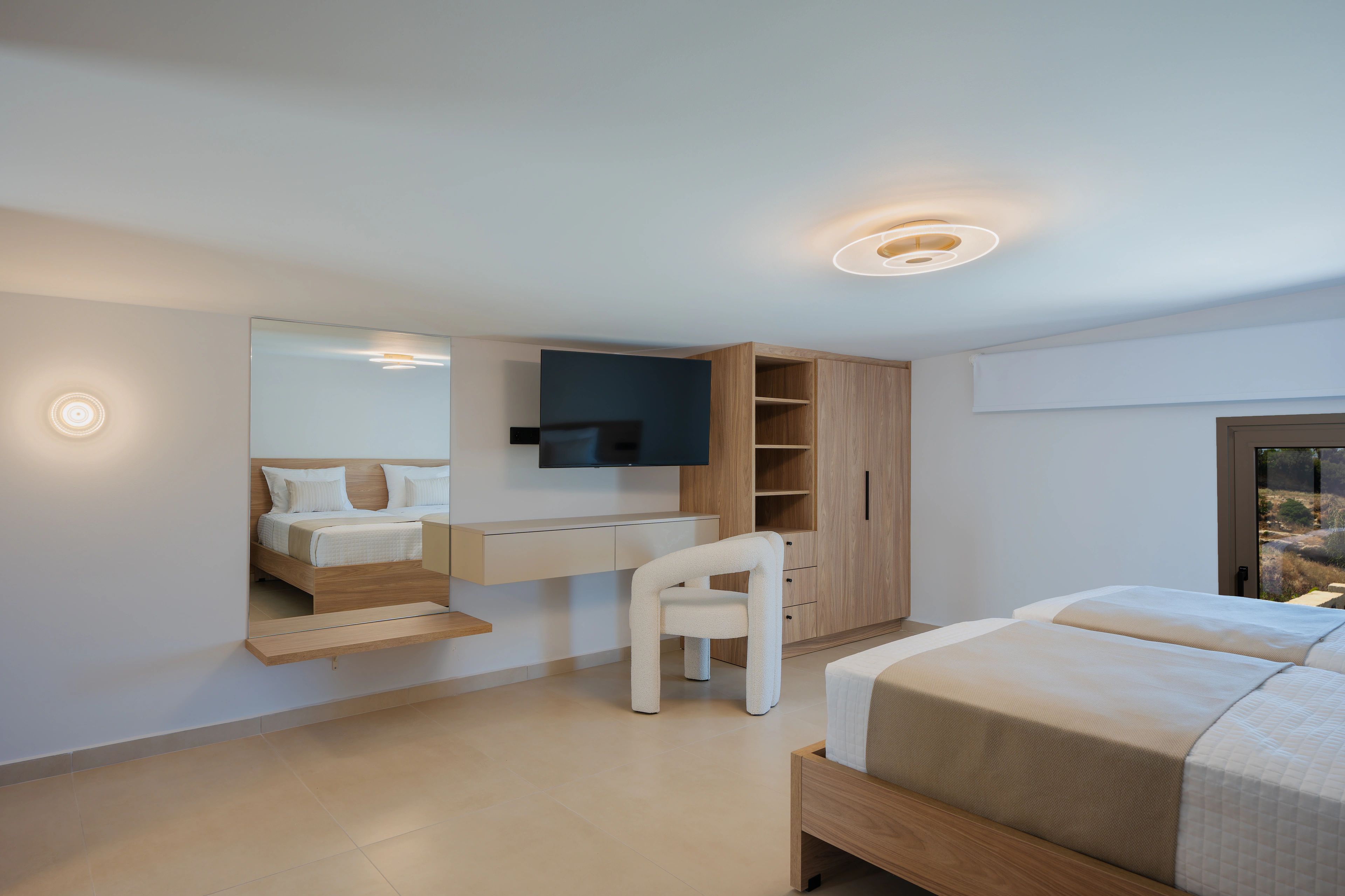 Wide view of Right Crete bedroom 03 with a king-size bed, desk and mirrored dressing area